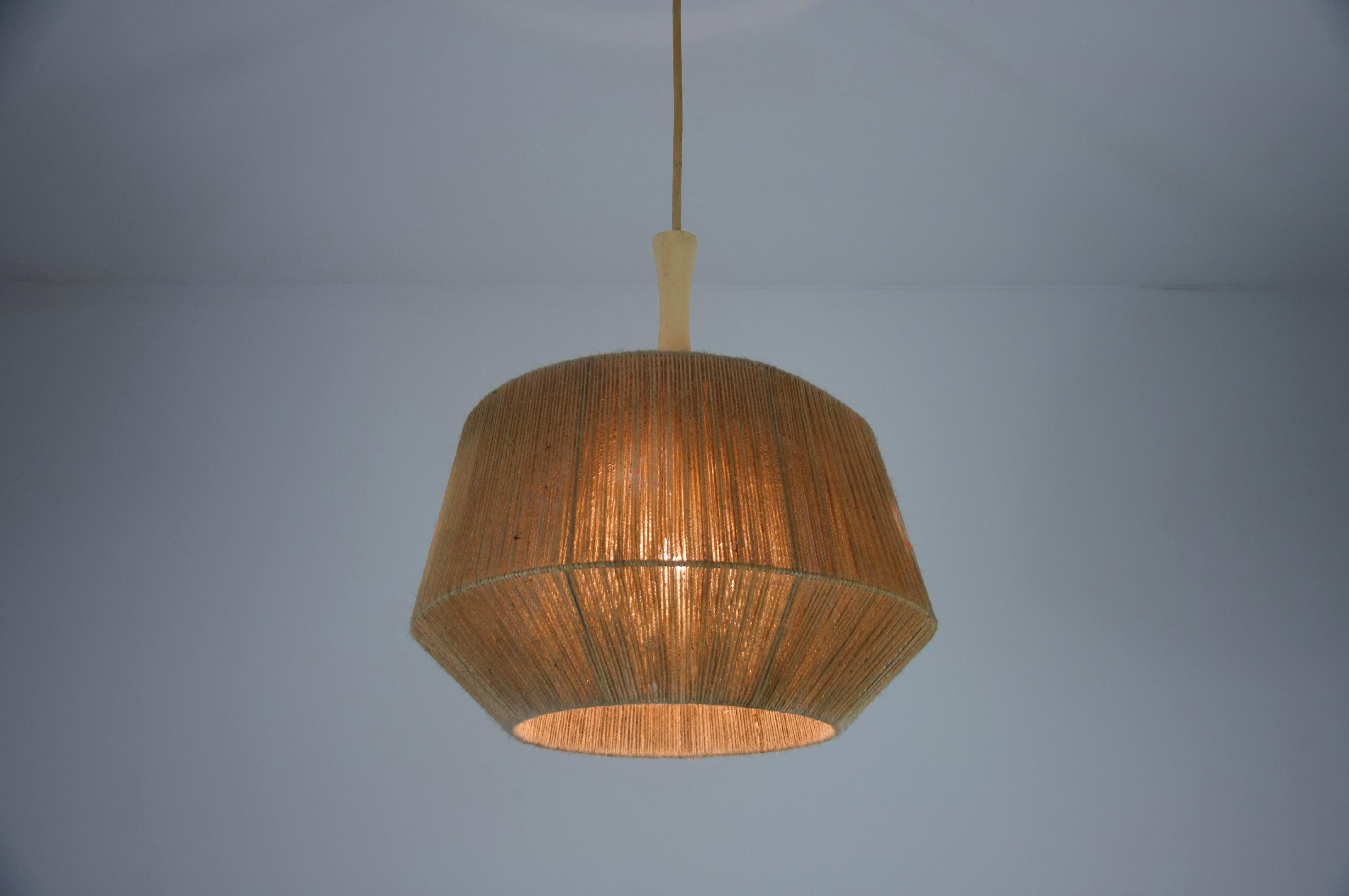 Exquisite Rattan Ceiling Lamp, a true embodiment of mid-century German design. Crafted in the 1970s, this lamp features a sophisticated shape made from finely natural elements, showcasing the artistry of traditional rattan weaving.

The lamp