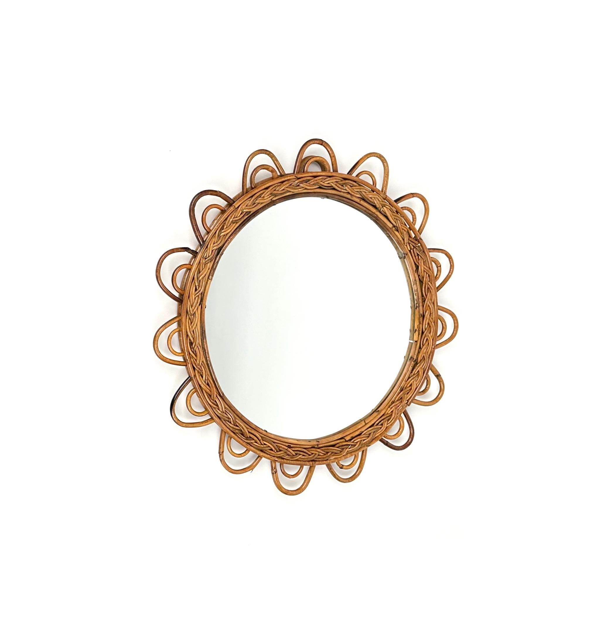 Beautiful rattan sunburst flower shaped wall mirror.

Made in Italy in the 1960s.