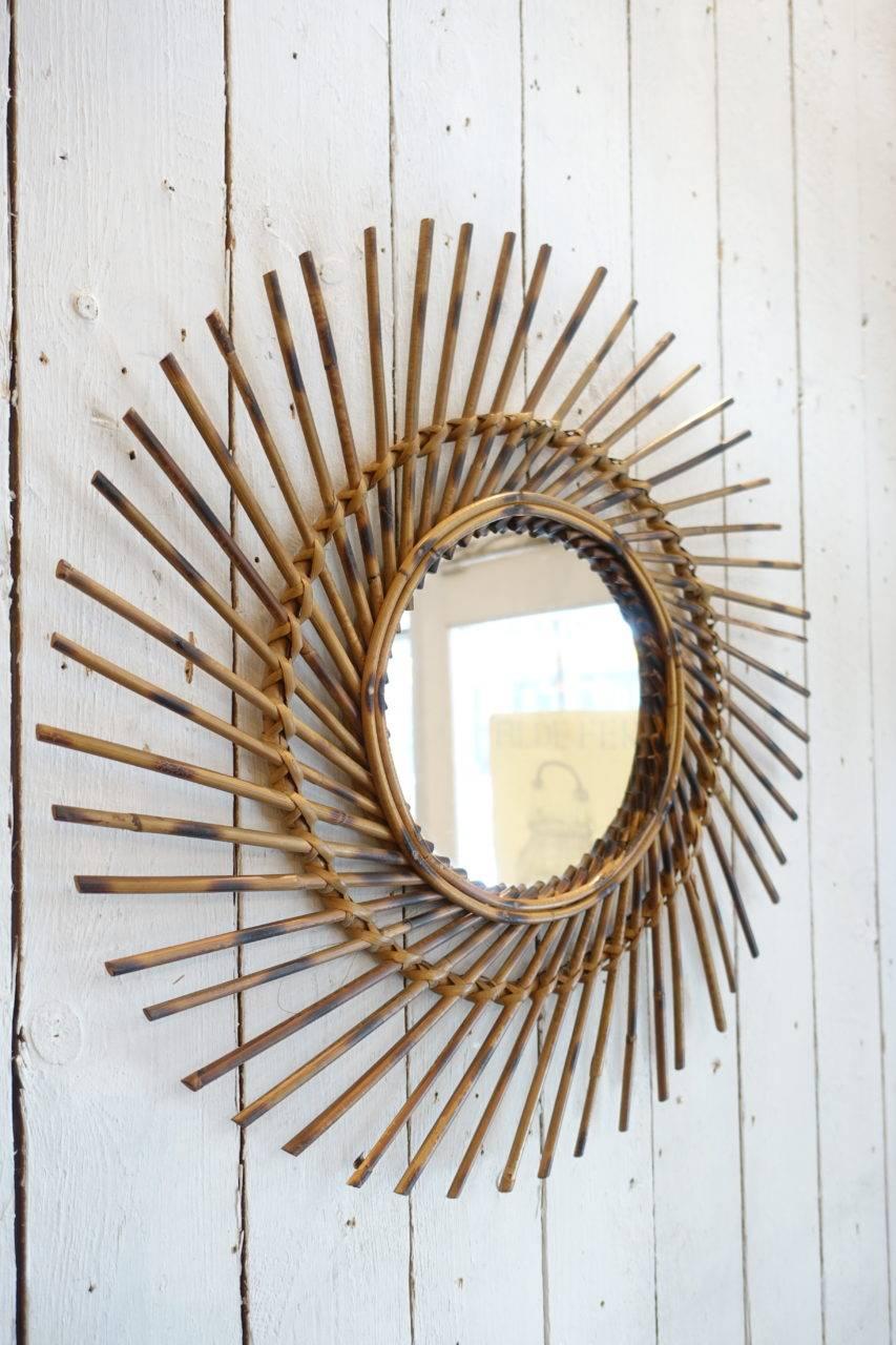 Wonderful vintage midcentury round French rattan / wicker mirror. With its original glass and eye catching frame. Gorgeous patina. Hand weaved in a stylish fashion, circa 1950s. Super decorative and spot on for today’s interior tendencies.
