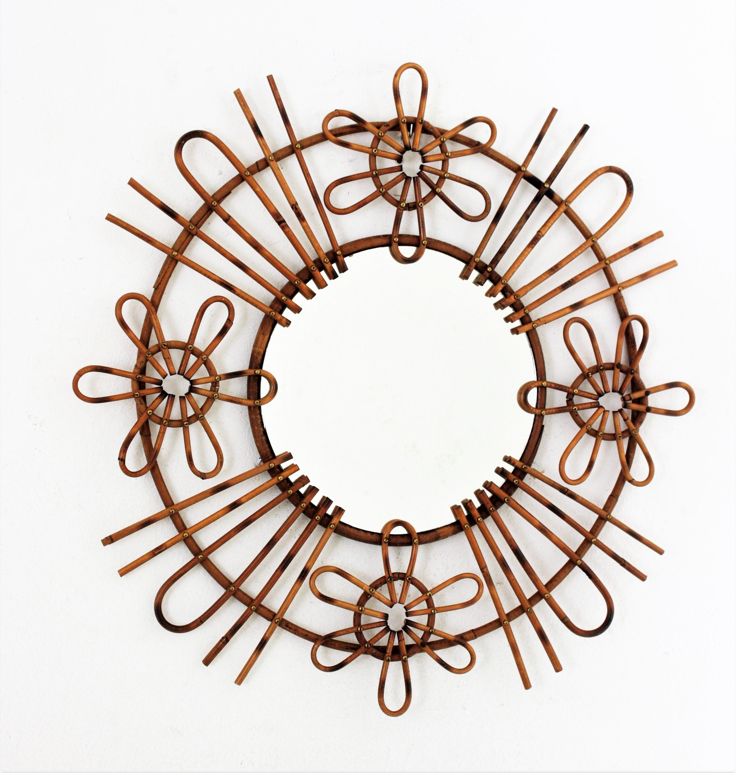 Rattan Spanish Modernist handcrafted sunburst mirror with flower motifs. Spain, 1950s.
Mediterranean style handcrafted sunburst rattan mirror adorned by flowers on the frame. Unusual design.
This mirror will be a cool addition to any beach house,