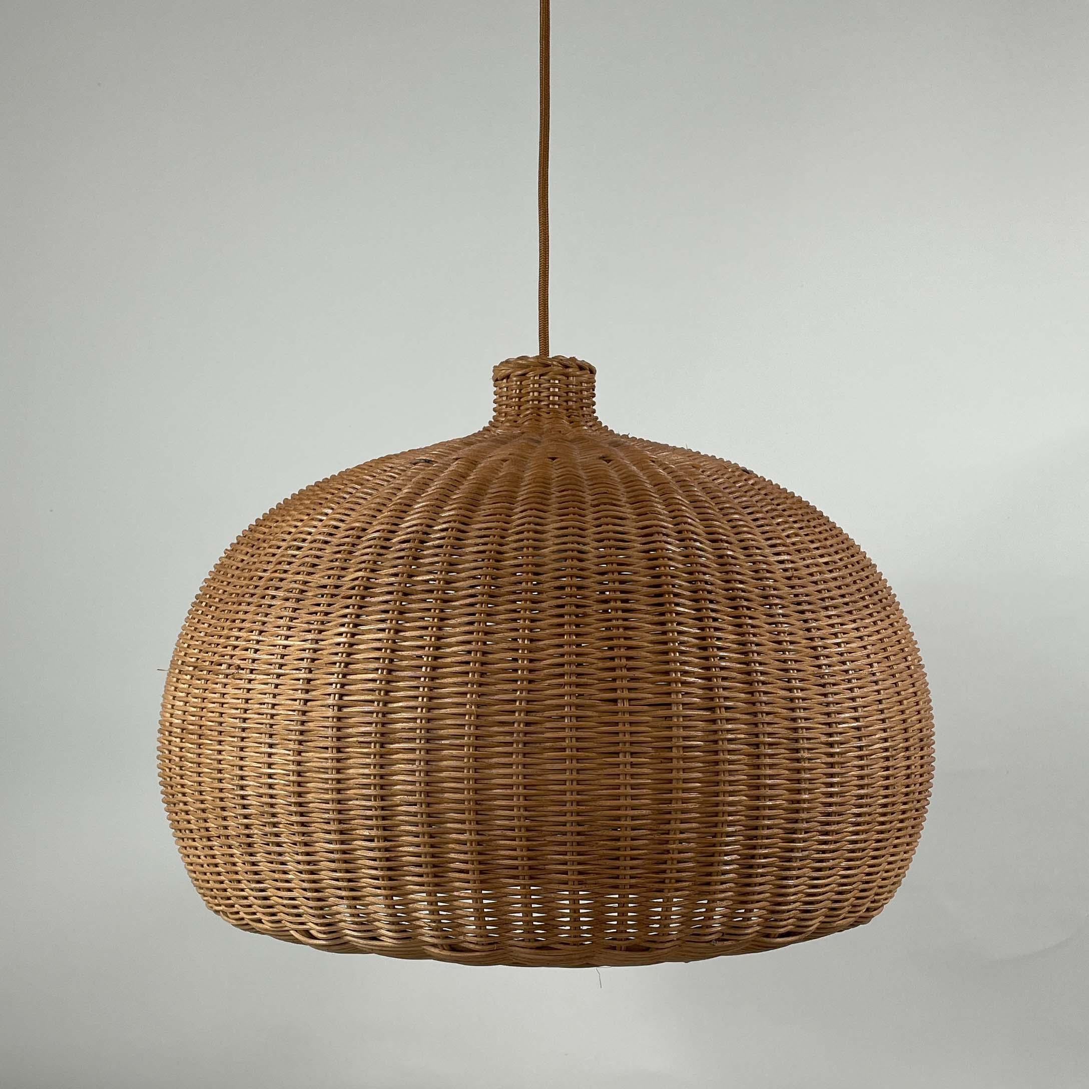 This rattan pendant or suspension light was designed and manufactured in Sweden in the 1960s. It features a large ball shaped lampshade, brown fabric cord and a brass canopy.

The light has been rewired for use in US and any other country of the