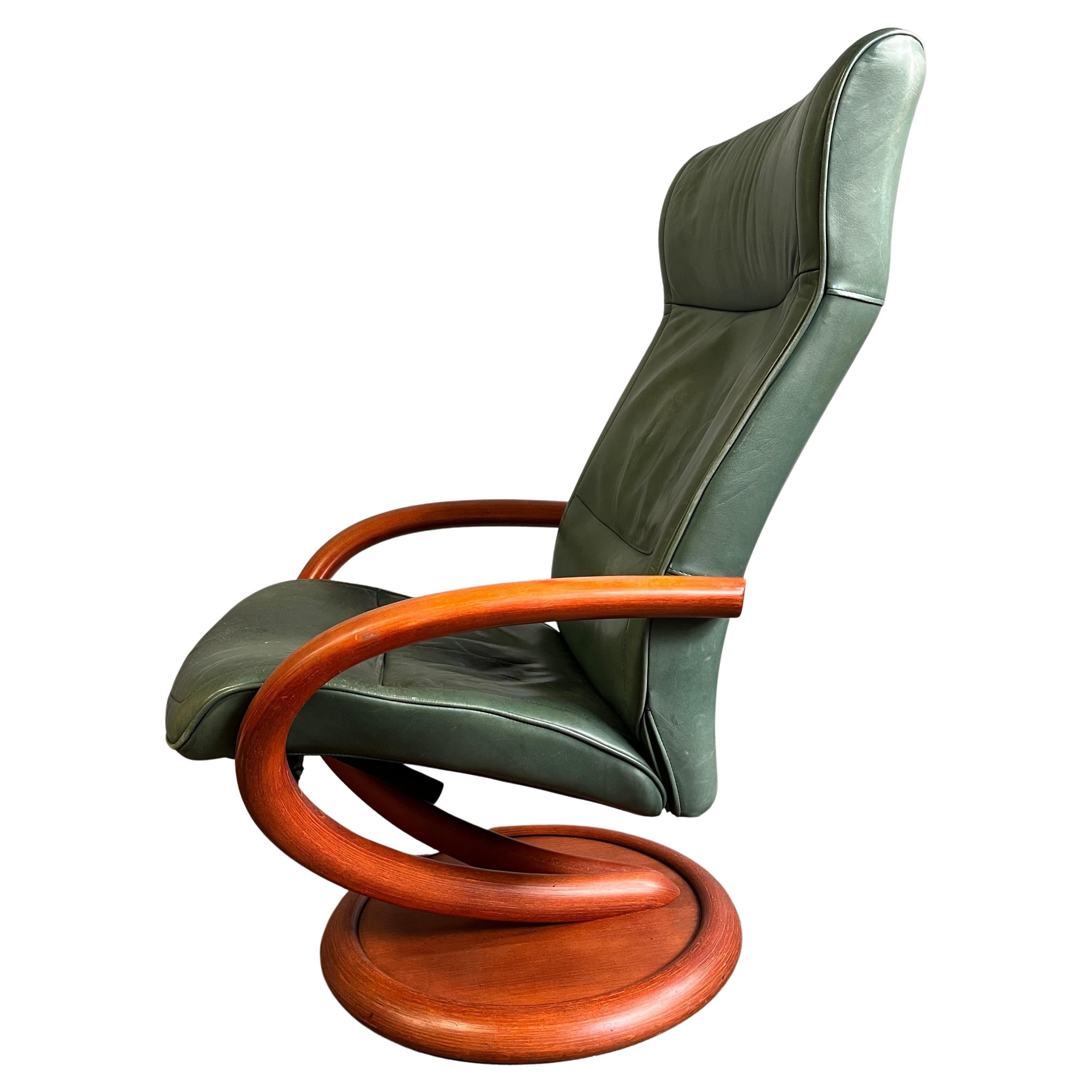 Unique reclining cantilevered lounge chair made of bent wood. This chair also swivels 360'. 

Green leather has some age. Leave as is or recover to your liking. 