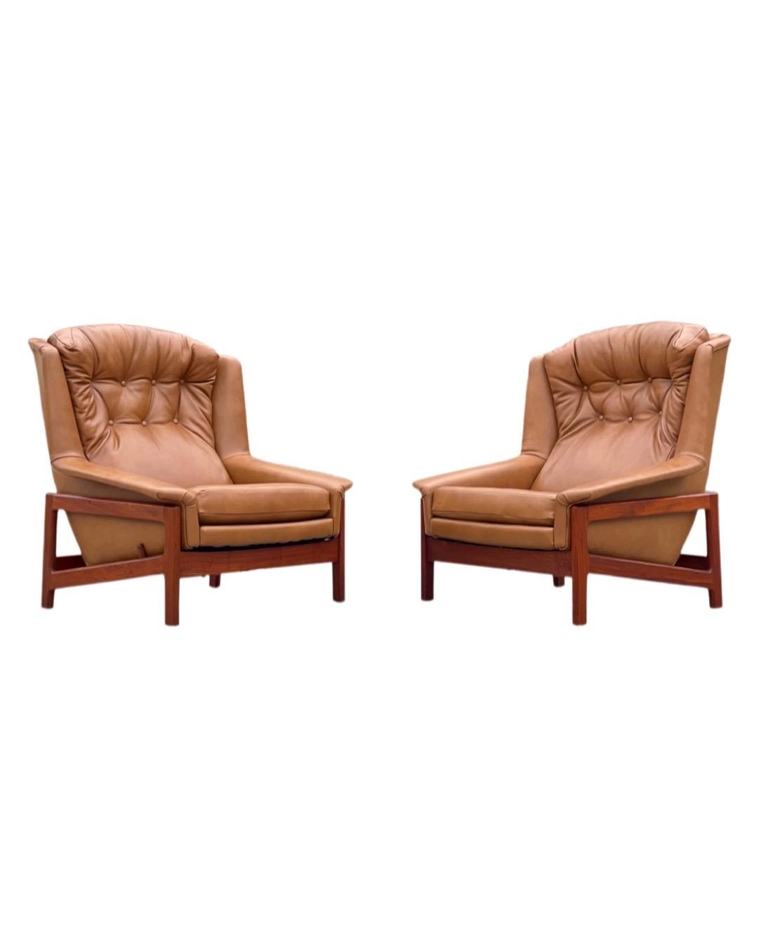 Unique on the market - rare pair of oversized rocking and reclining lounge chairs and ottoman by Folke Ohlsson for DUX. Built in Sweden, circa 1968. These were the top of the line model that DUX offered - each chair rocks smoothly within its base