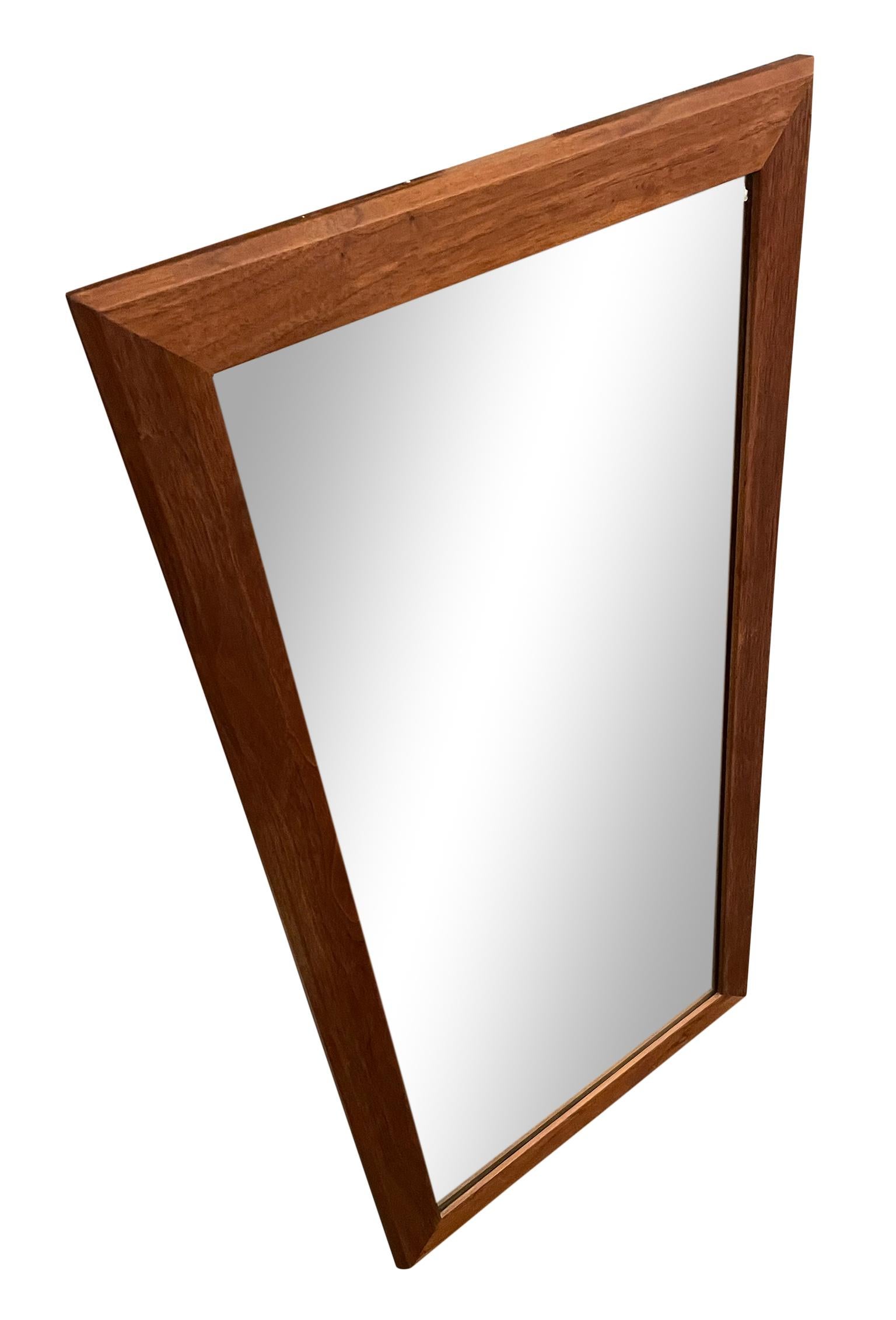 This wonderful Mid-Century Modern solid walnut american studio craft mirror. Will come with wire, wired to hang vertical. Beautiful vintage condition and great high quality woodworking. Finished back. Solid and heavy. In style of Nakashima. Made in