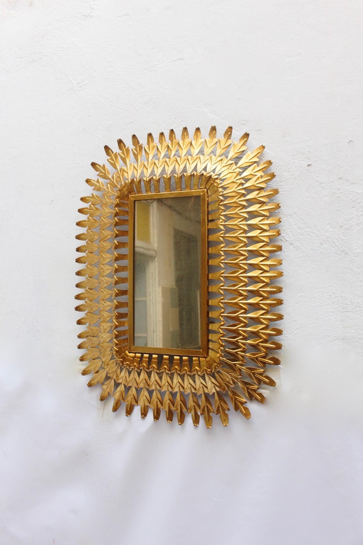 Midcentury large sunburst iron mirror, made in Spain during the 1950s.
The piece has been restored with gold leaf technic and remains with original mirror, featuring visible wear. We do prefer to leave the original mirror in its original condition.