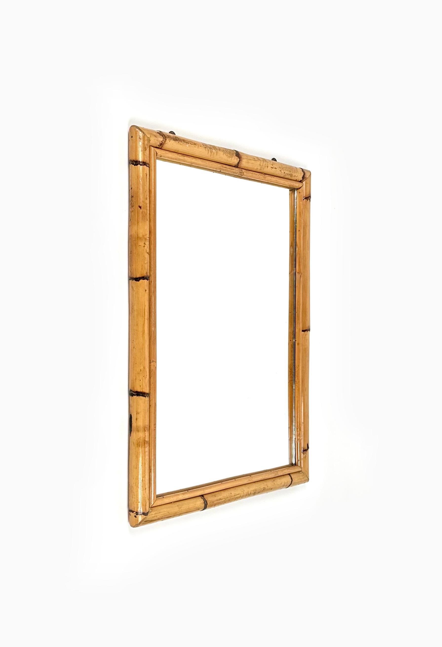 Beautiful rectangular wall mirror double bamboo frame.

Made in Italy in the 1970s.