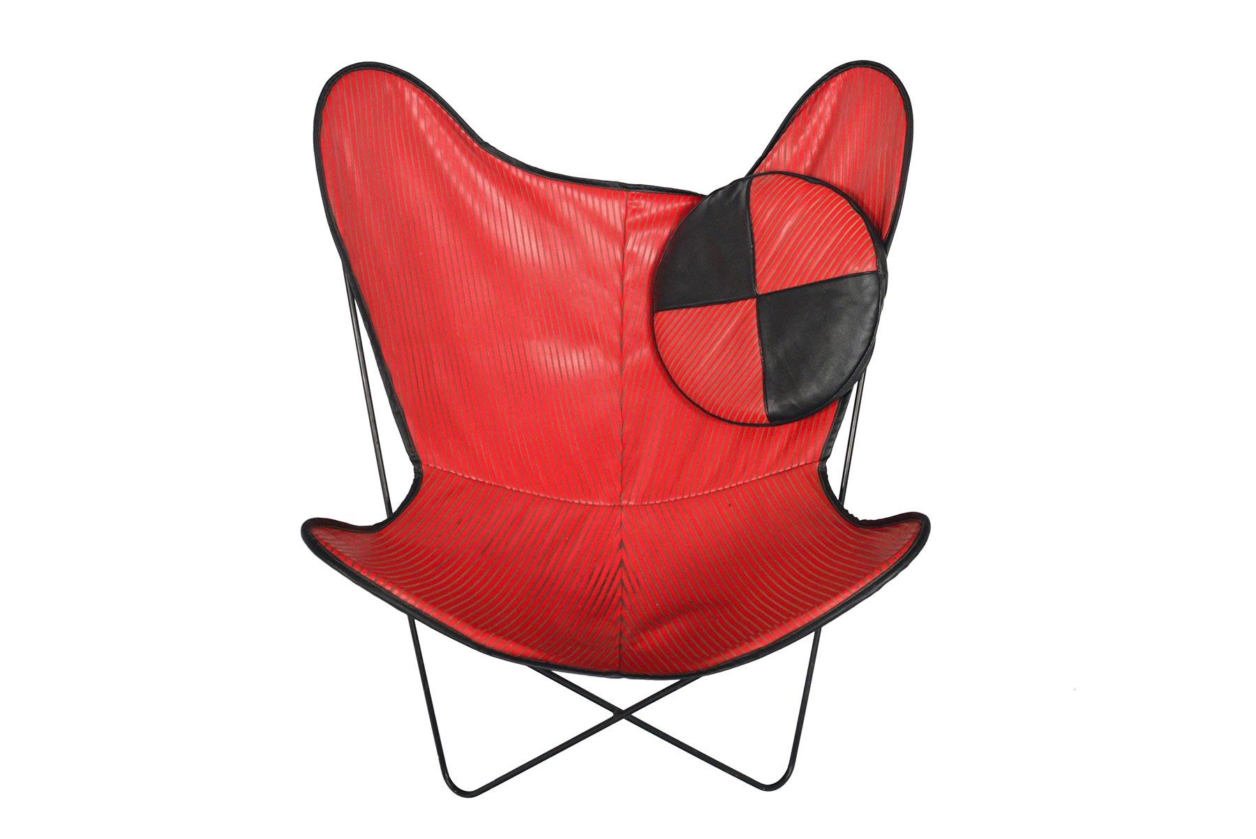 Originally designed in 1938, the butterfly chair has endured as a sought after element for architectural interiors. This completely original 1950s piece hails from Denmark and showcases a period perfect color blocked upholstery. Black vinyl trims a