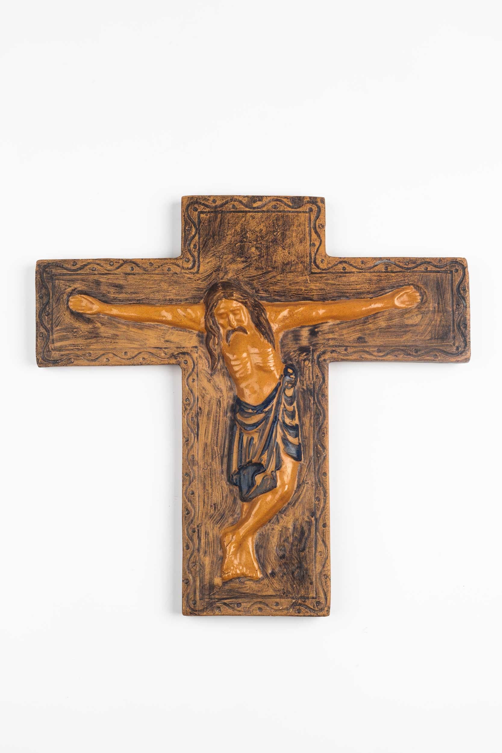 Midcentury European wall crucifix in glazed, hand painted ceramic. From a large collection of vintage crosses handmade by Flemish artisans. 

From modernism to brutalism, the crosses in our collection range from being as futurist as a modernist