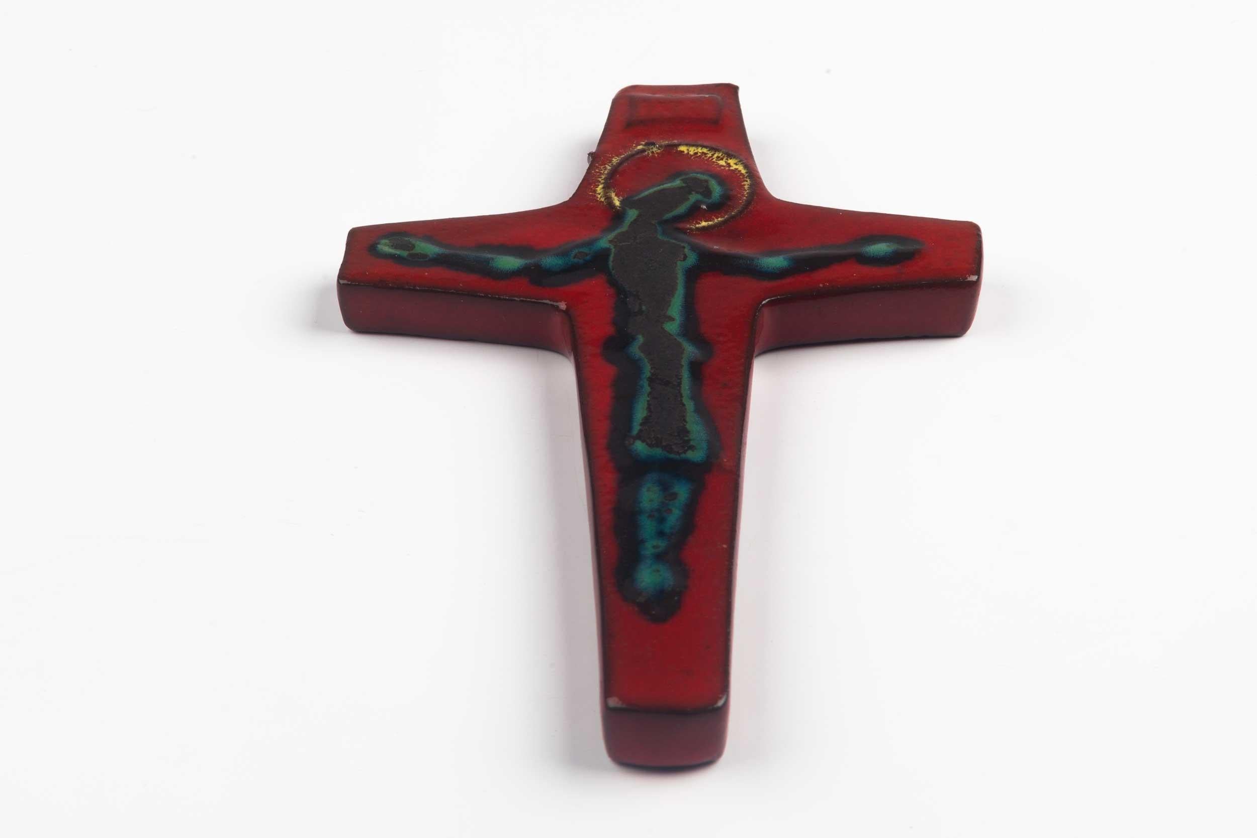 Midcentury European wall cross in glazed, hand painted ceramic. Astounding colors, burgundy, blue, black and gold. From a large collection of vintage crosses handmade by Flemish artisans. 

From modernism to brutalism, the crosses in our
