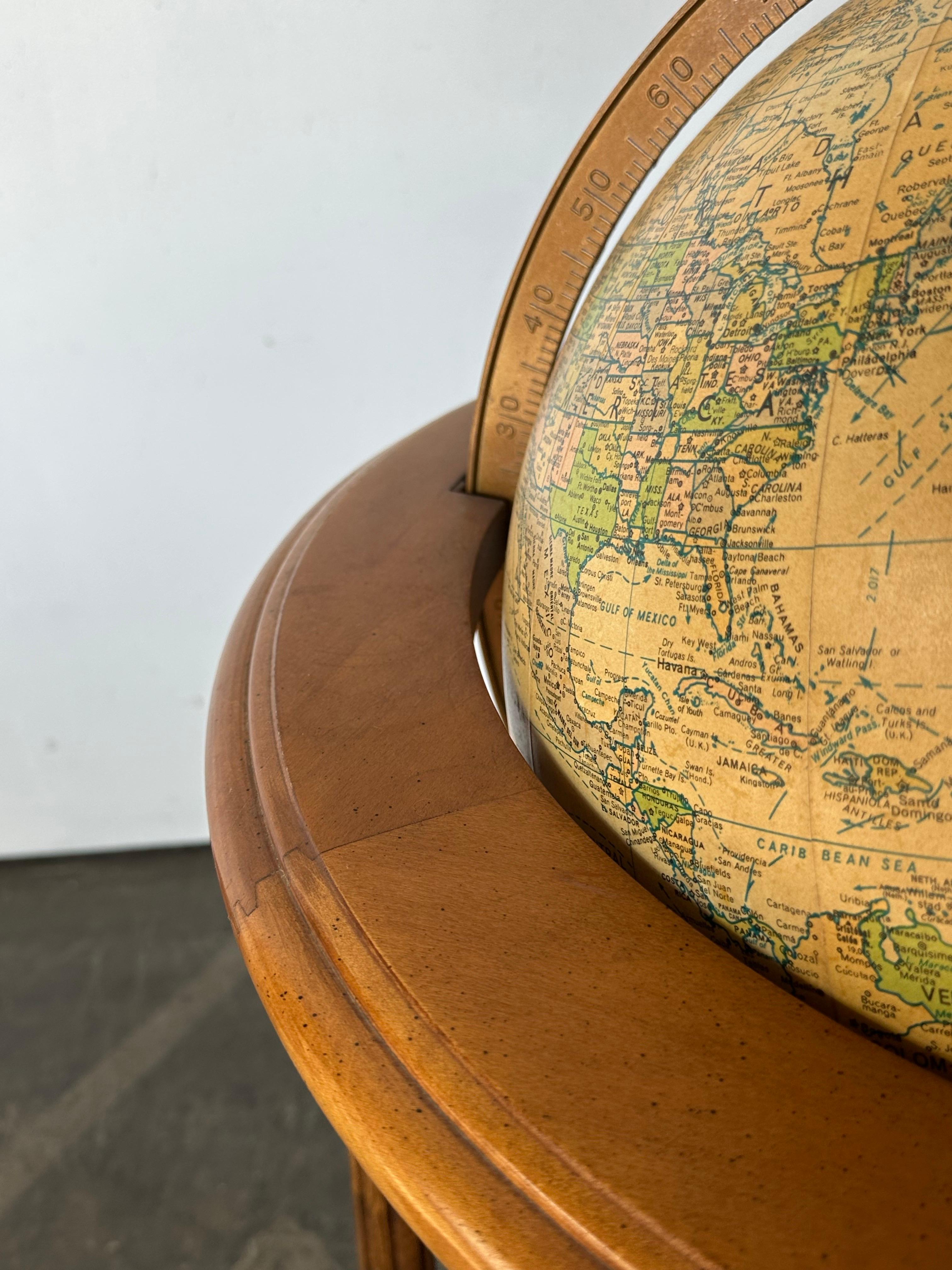 Beautiful Replogle Heritage globe on solid wood stand. Gorgeous honey patina adorns the frame, which supports the 16” globe. The globe has a fabulous illuminated effect, with 2 brightness settings. In original condition, with normal light wear.