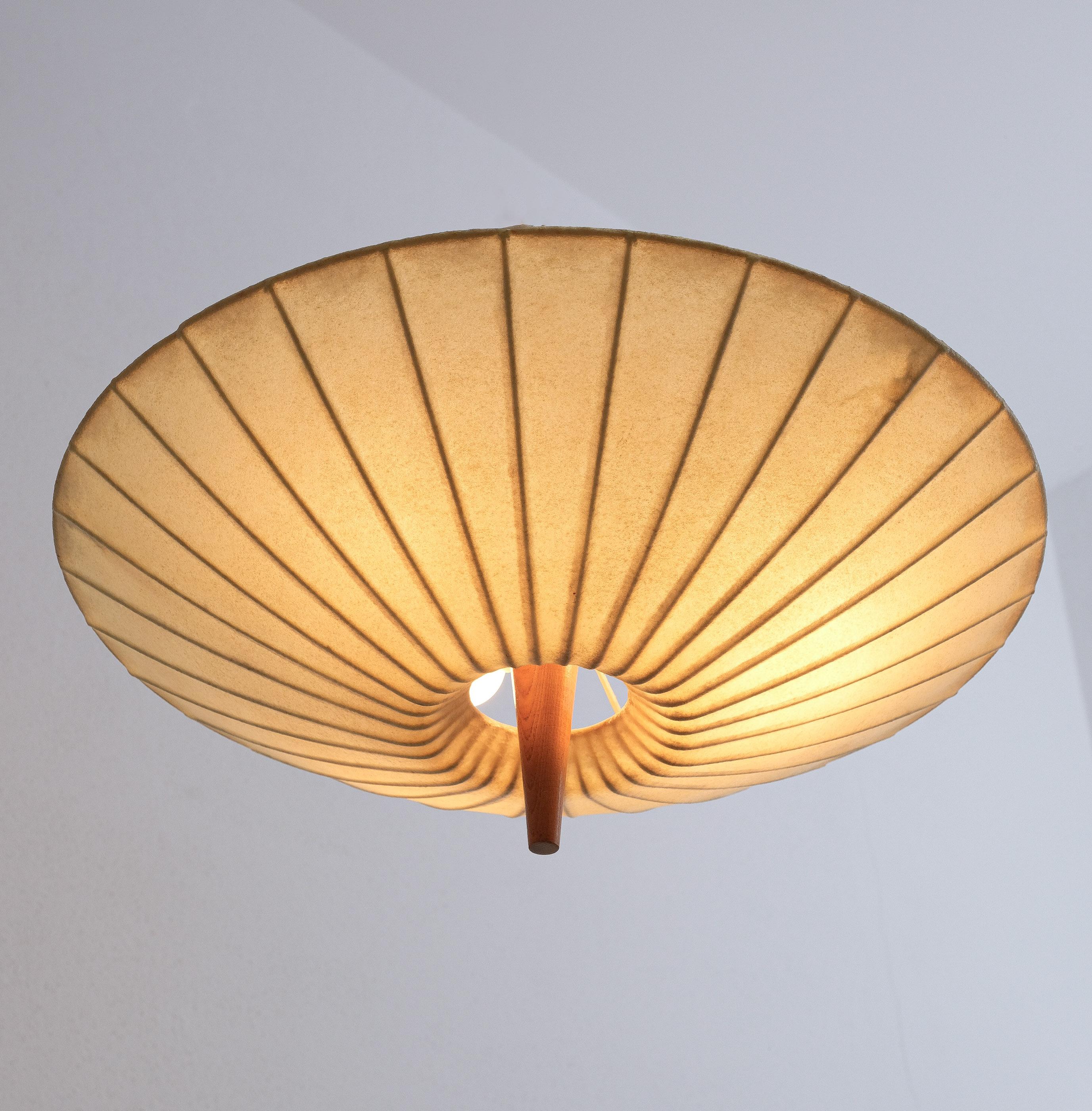Midcentury resin cocoon flush mount with piercing wooden stem, Italy, circa 1960

Very well preserved flush mount lamp with a 19.5