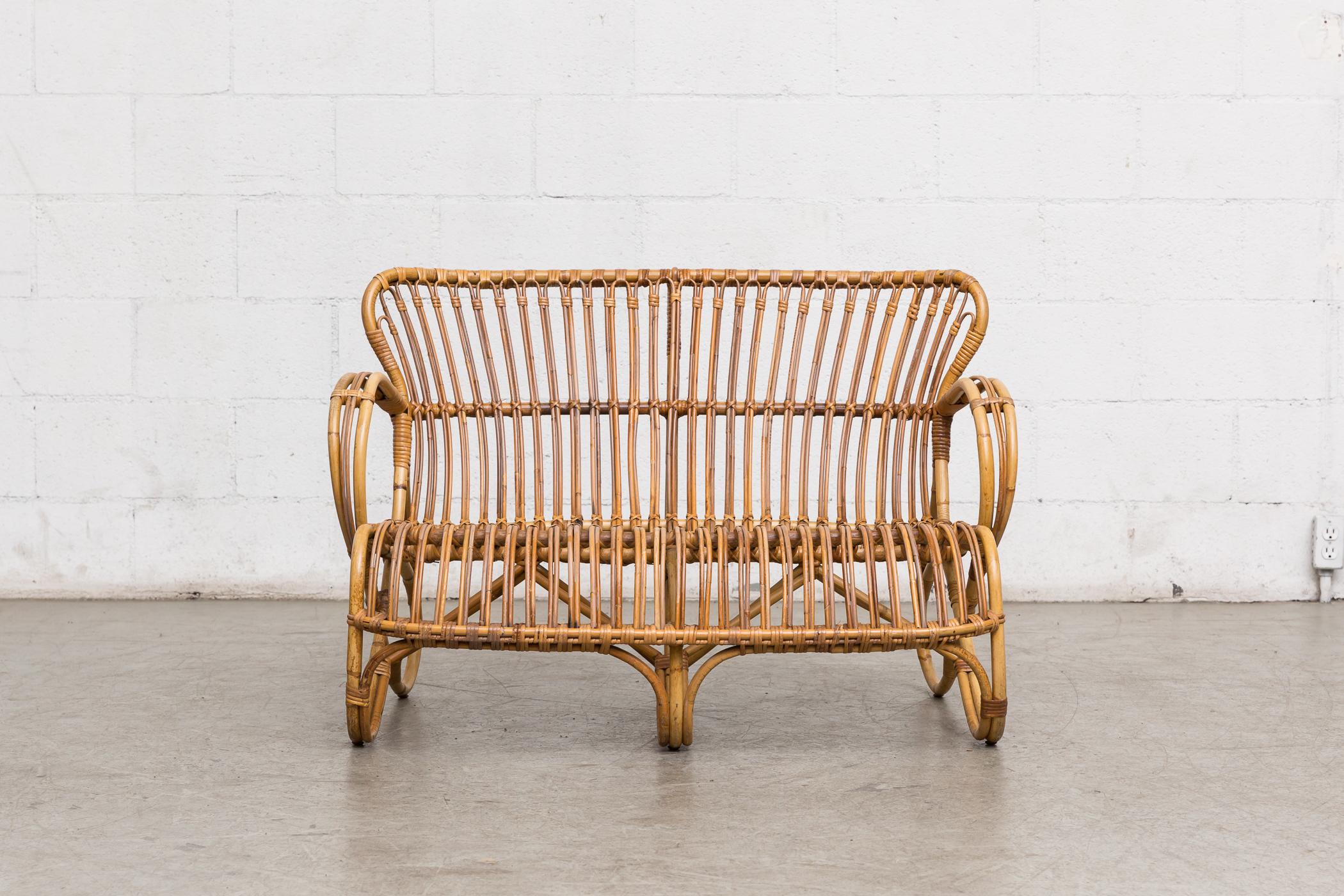 Sweet little bamboo love seat in good original condition with wear consistent with its age and usage.