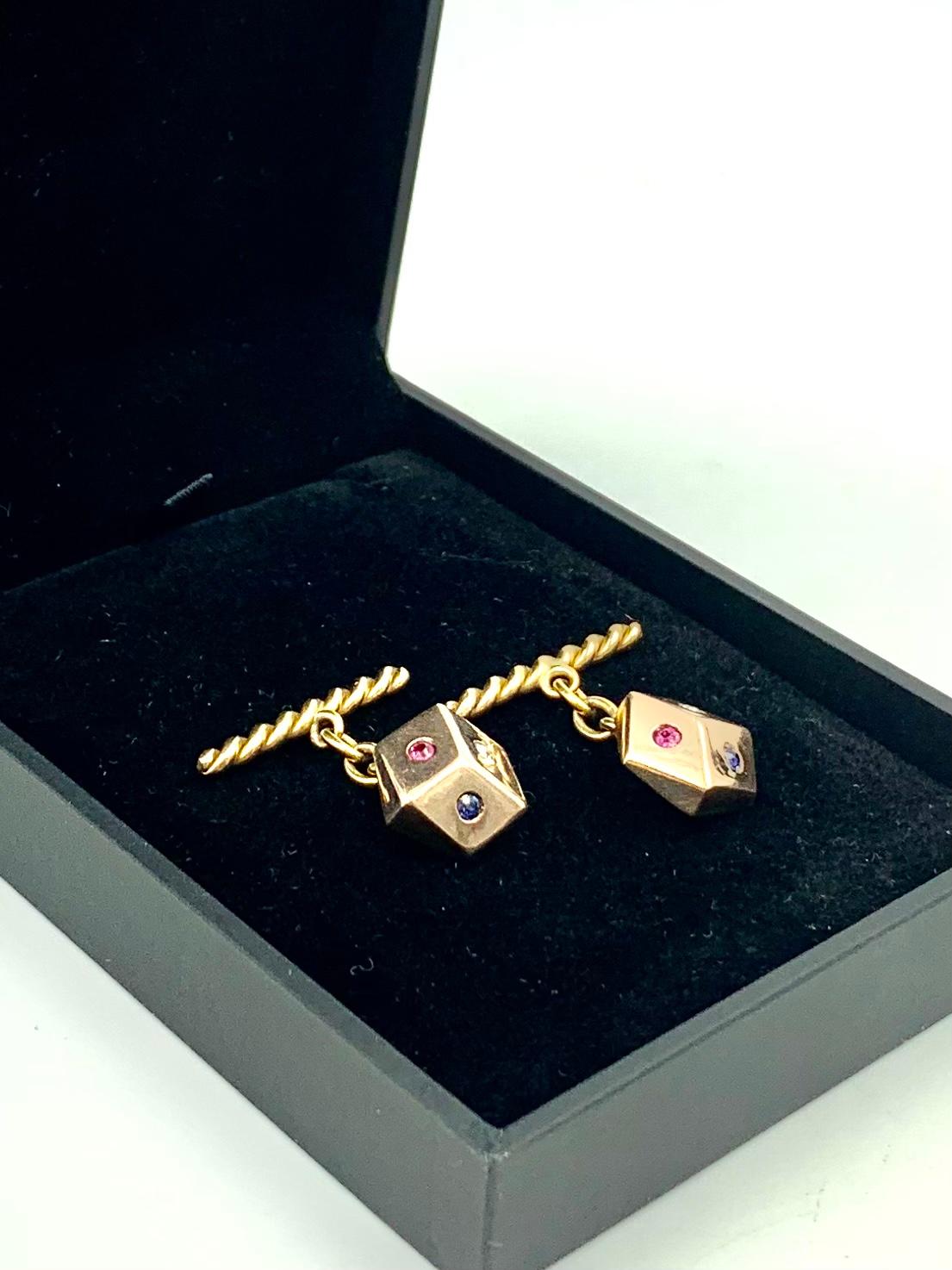 Classic symbol of chance and good luck, great Retro Midcentury pair of diamond, sapphire and ruby 14K rose and yellow gold dice cufflinks.
The rose gold dice are three dimensional, each set with a round European cut diamond, sapphire and ruby,