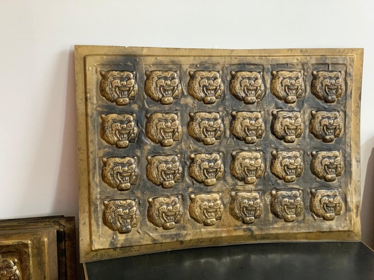 Truly unique midcentury decorative tiles, made to resemble late 19th century tin with bronze finish ceiling or wall tiles. Impressed with signature of designer. Roaring tiger, repeated, lined up, in a composite material, with aged bronze finish. A