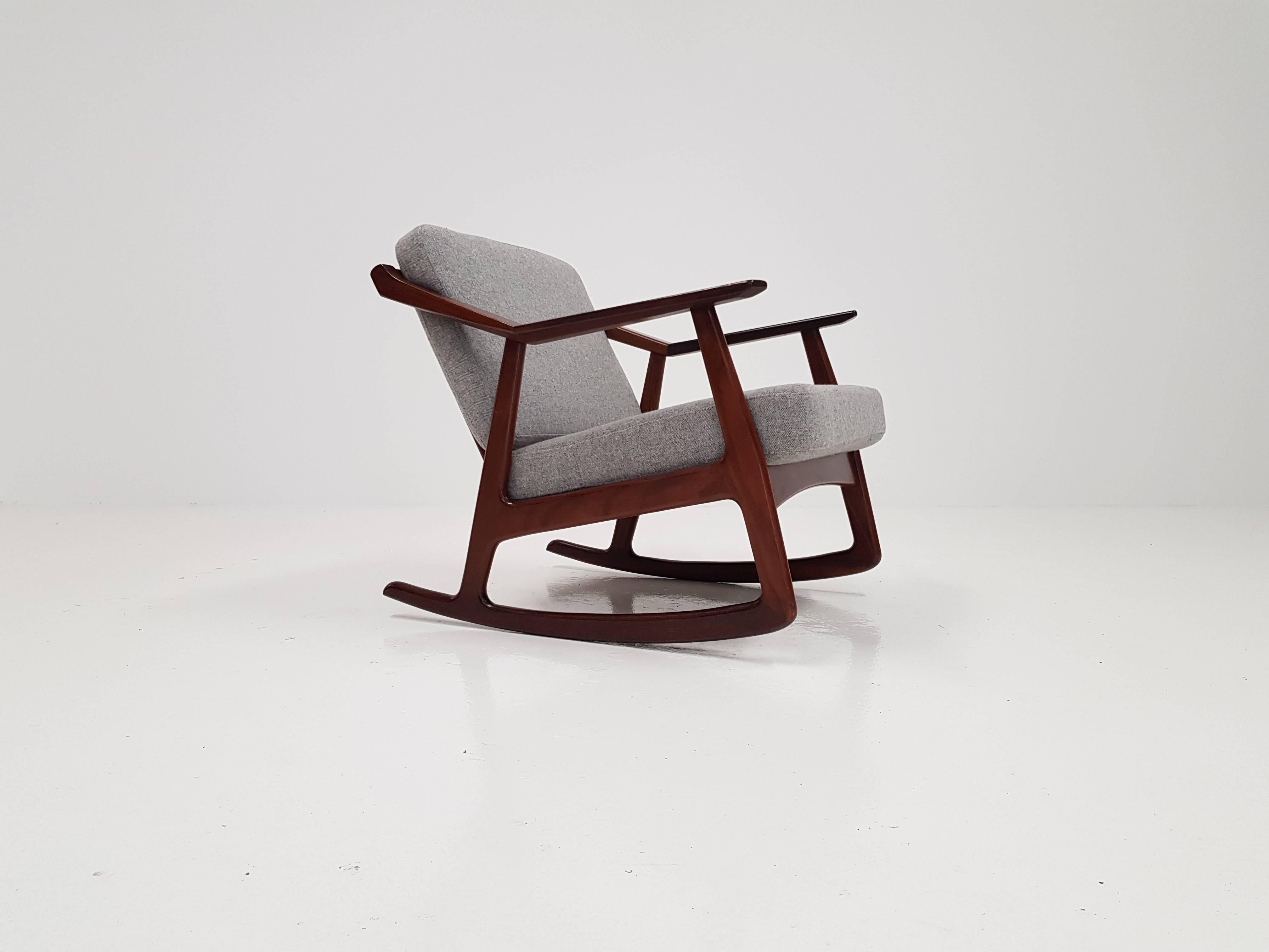 A rare midcentury rocker designed by H. Brockmann-Petersen, with an angular refinished teak frame and new grey fabric with slight Herringbone detail the piece has a great look.

 