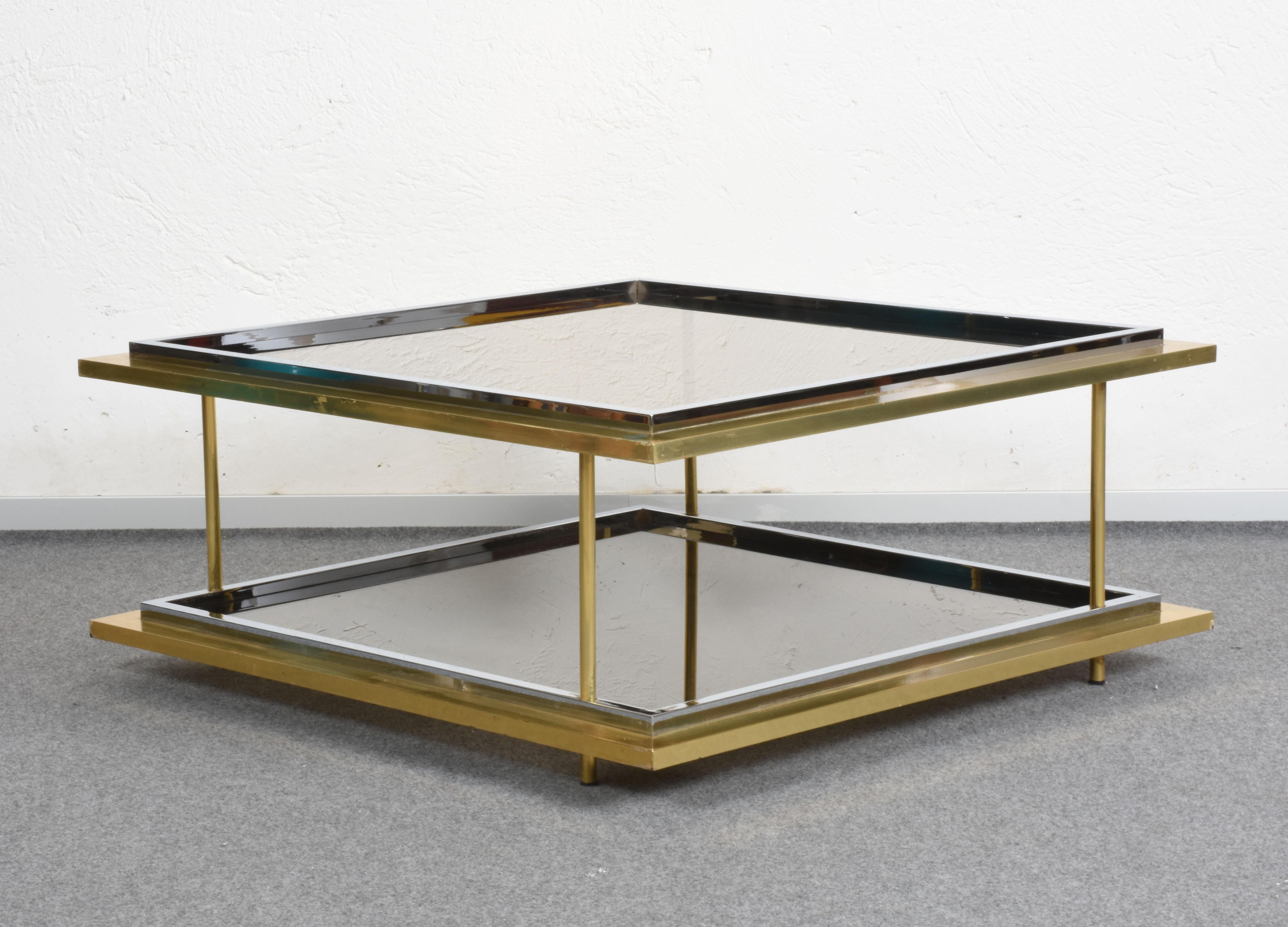 This iconic coffee table was designed by Romeo Rega, one of the few 1970s-era.

Like most of Rega's production, this clean-lined modernist piece is characterized by a two-level squared geometric shape and made seductively elegant by chrome, brass