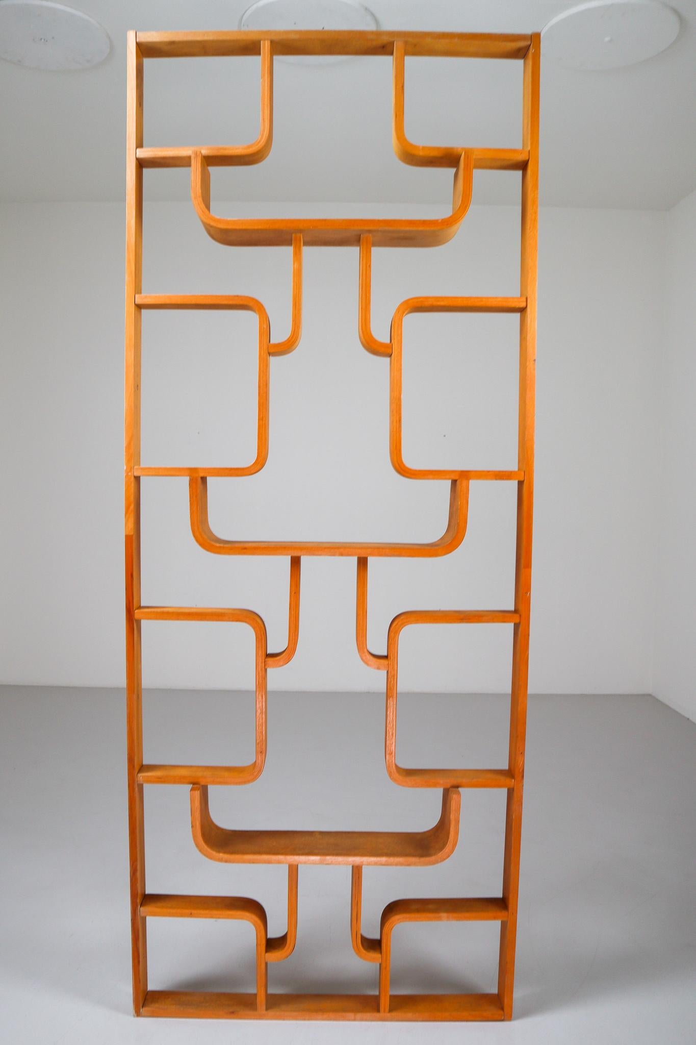 A unique 1960s piece of Czech design, part of a limited five year production. Can be used as a wall-mounted shelving unit or room divider. Square edges in blond color plywood and features geometric patterns. Designed by Ludvik Volak in the Czech