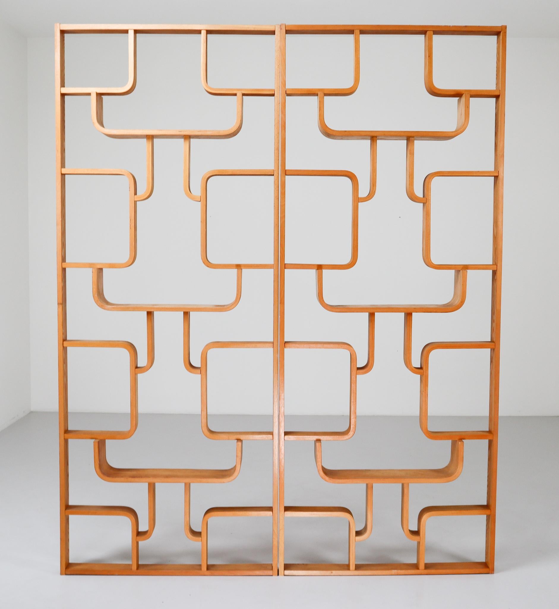 A unique set of two blond room dividers from a villa from Prague purchased from the original owner. These objects can be used as a wall-mounted shelving unit or room divider. Square edges in blond color plywood and features geometric patterns.