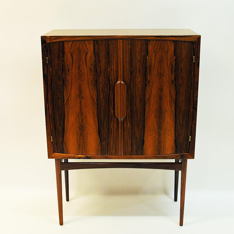 A beautiful vintage bar cabinet 'Baccus' by Torbjørn Afdal for Bruksbo A/S designed  in 1955 and produced at Mellemstrands Møbelfabrikk AS. Norway.
The cabinet is made of rosewood and black formica. Furnished with a handy pull-out preparation