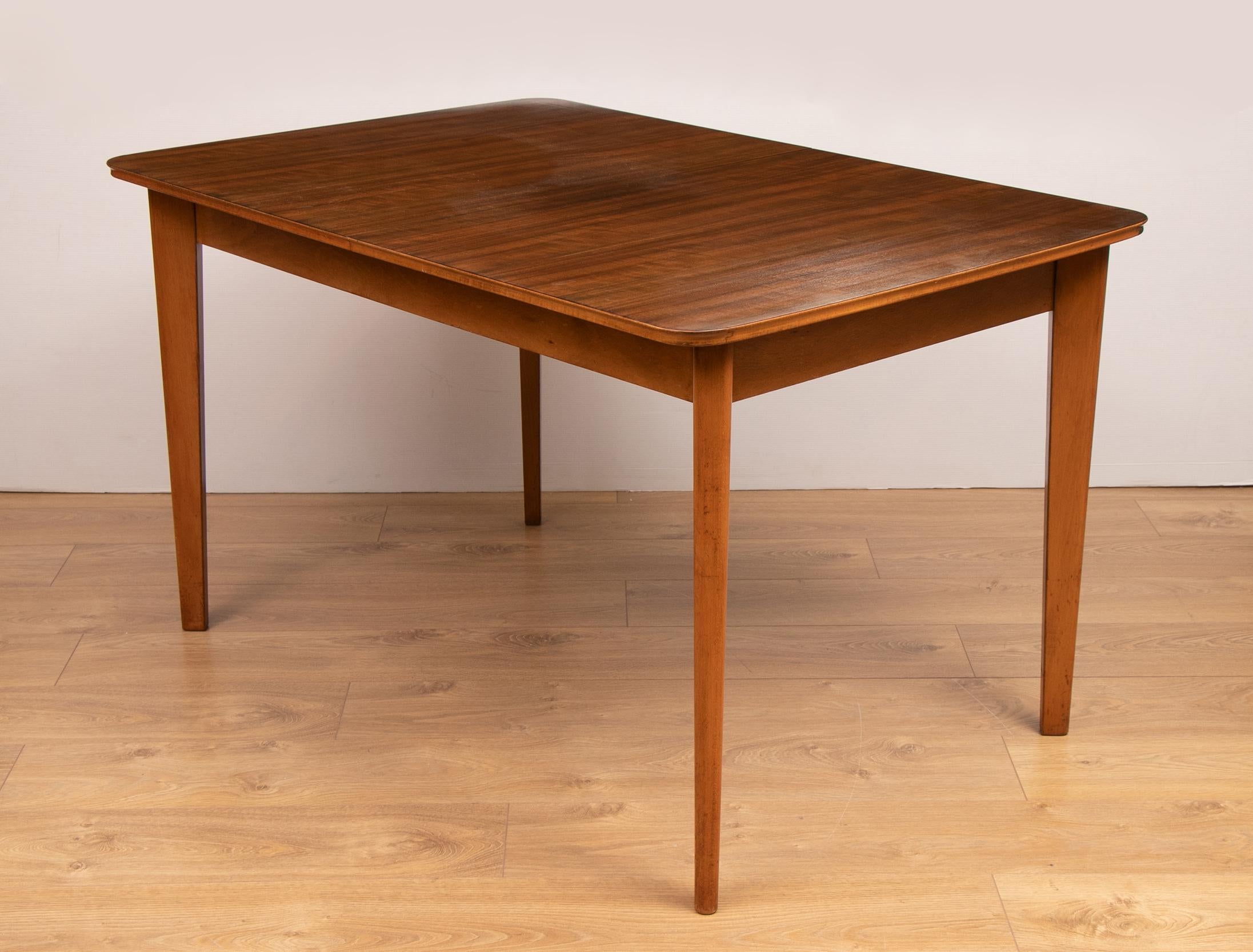 A stunning midcentury dining table and 4 chairs by Gordon Russell Ltd, England, 1955. The dining suite was bought as wedding present in 1955 from Bourne & Hollingsworth department store on Oxford Street, London. Chairs newly reupholstered with