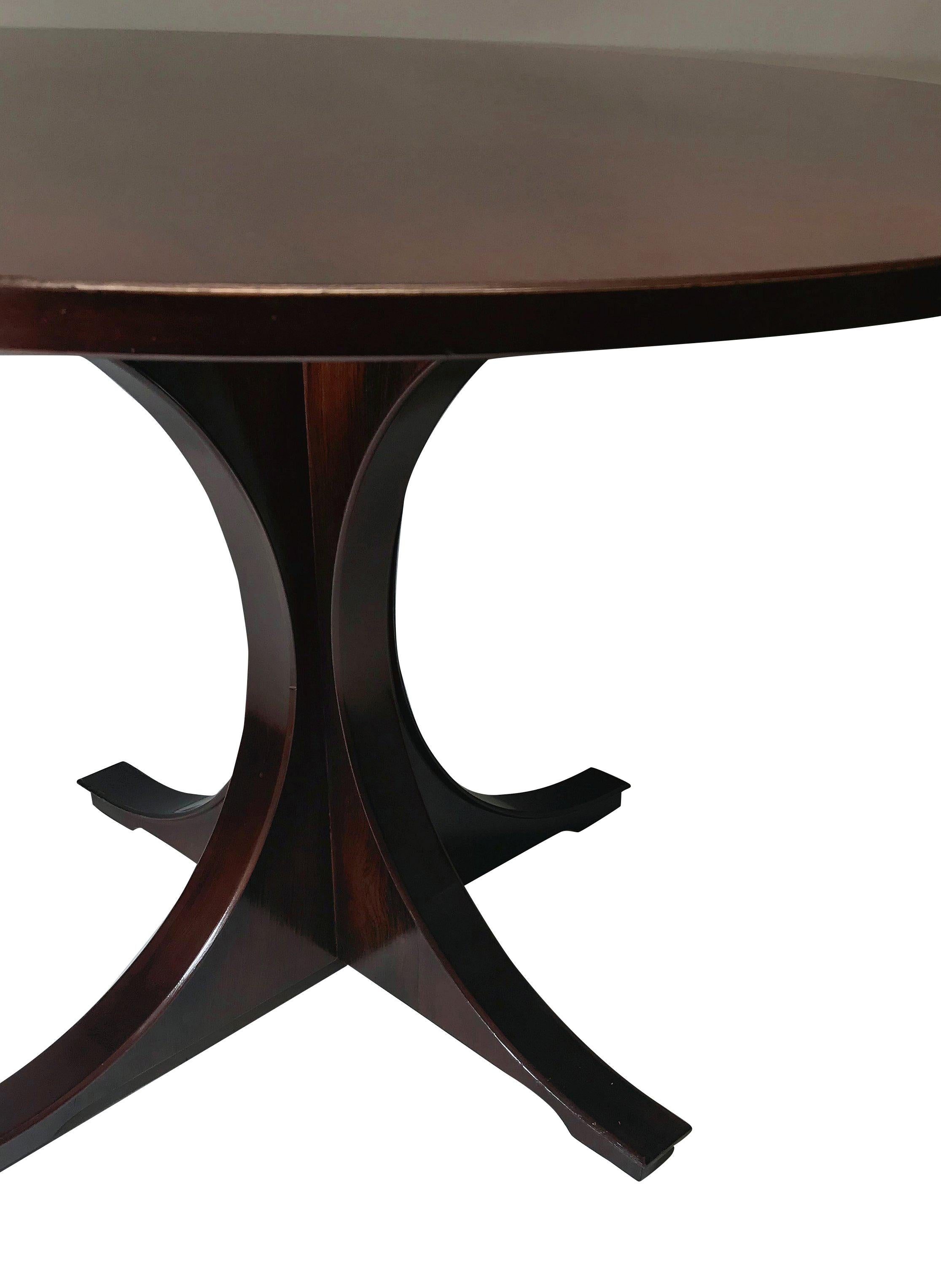 An Italian sculptural centre table in rosewood. On an attractive splayed base and good figuring to the top.