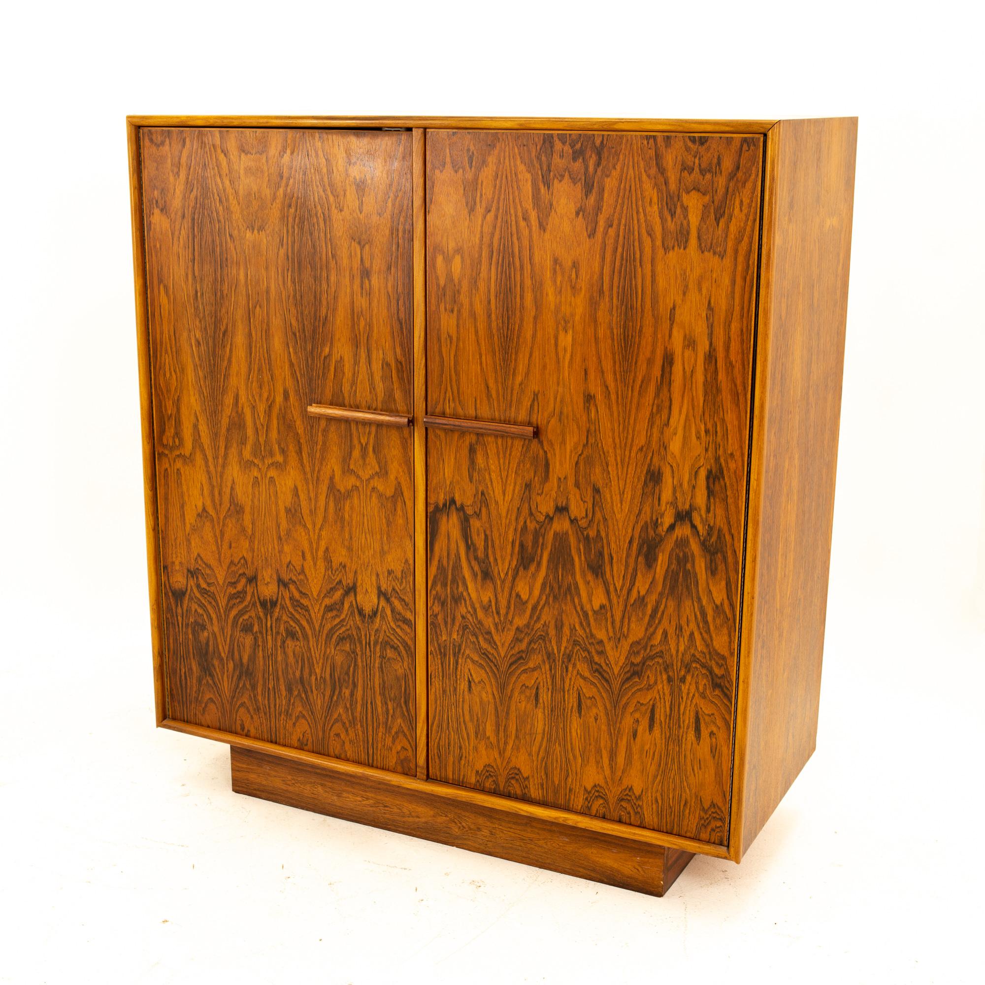 Mid Century rosewood highboy armoire dresser
Dresser measures: 42 wide x 18.5 deep x 47 high

All pieces of furniture can be had in what we call restored vintage condition. That means the piece is restored upon purchase so it’s free of watermarks,