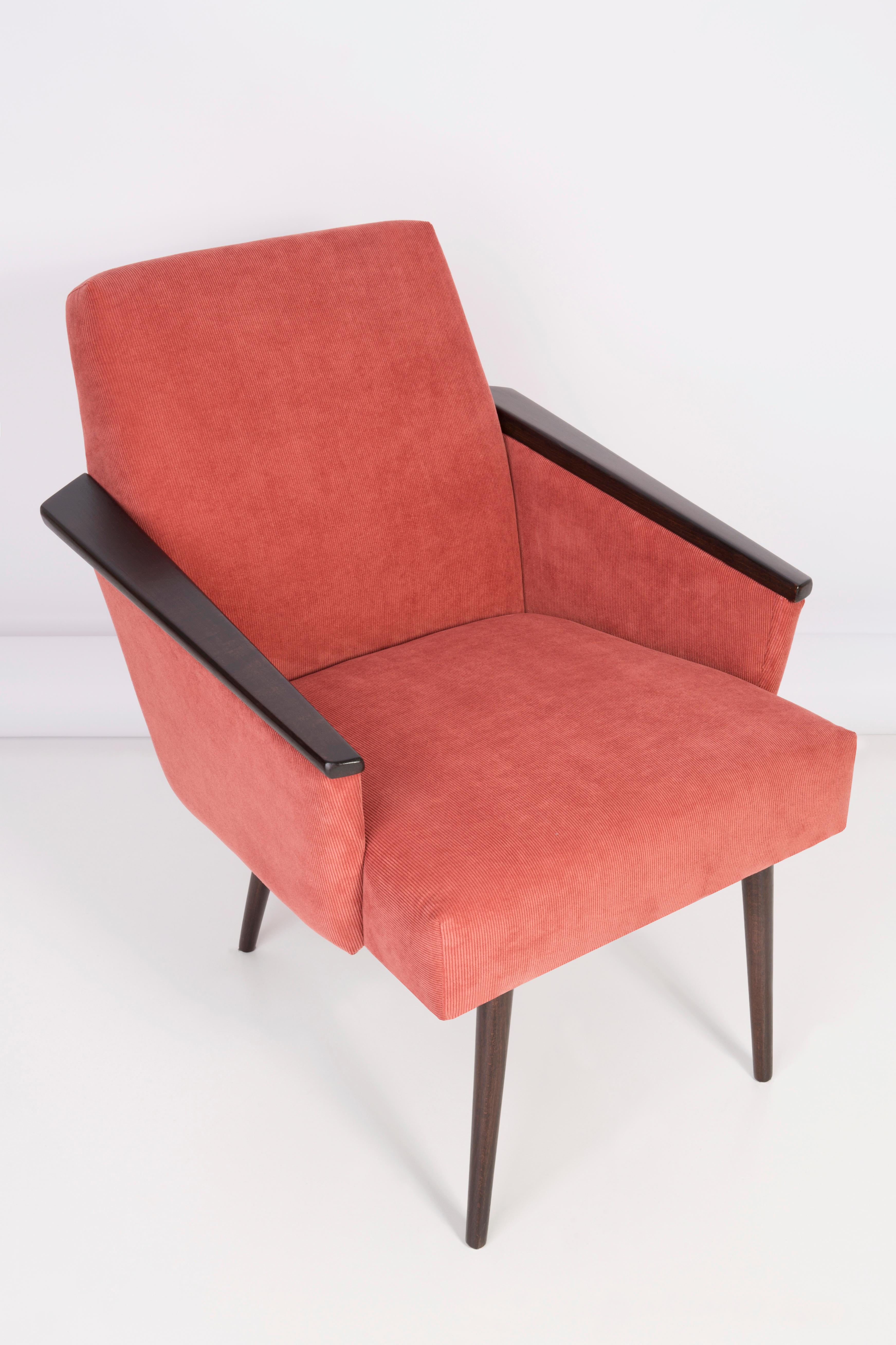 German armchair produced in the 1960s in Berlin. The armchair is after a thorough renovation of upholstery and carpentry. The wooden frame is thoroughly cleaned and covered with a semi-matte varnish in the color of a palisander. The upholstery is