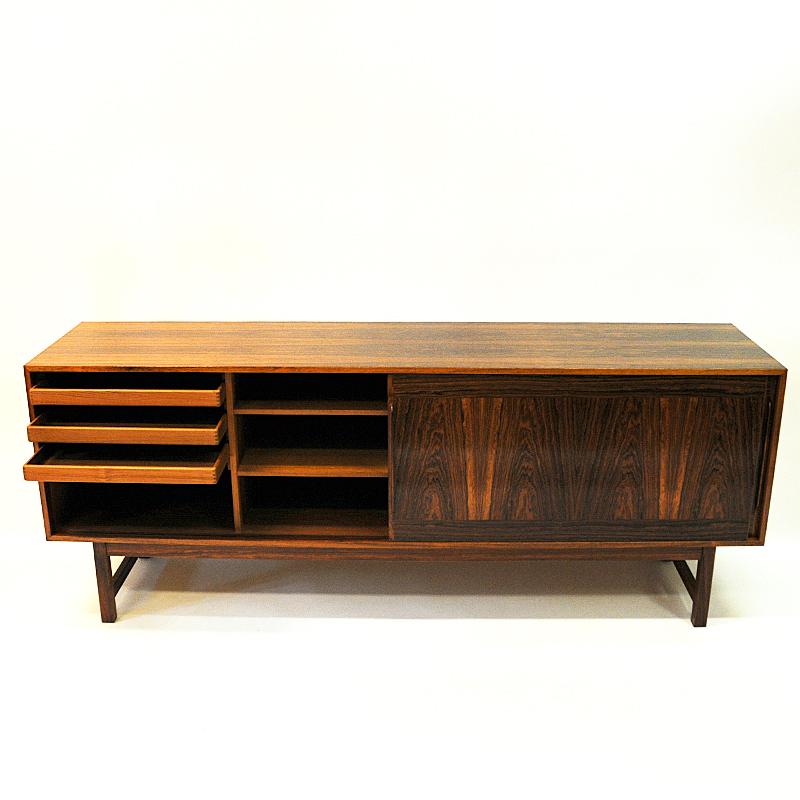 Beautiful rosewood vintage sideboard Credenza by Karl-Erik Ekselius for JOC Möbler in Vetlanda 1960s Sweden. A vintage sideboard with lovely patterns and the design is clean and simple. Large sliding doors and good storage options with great design.