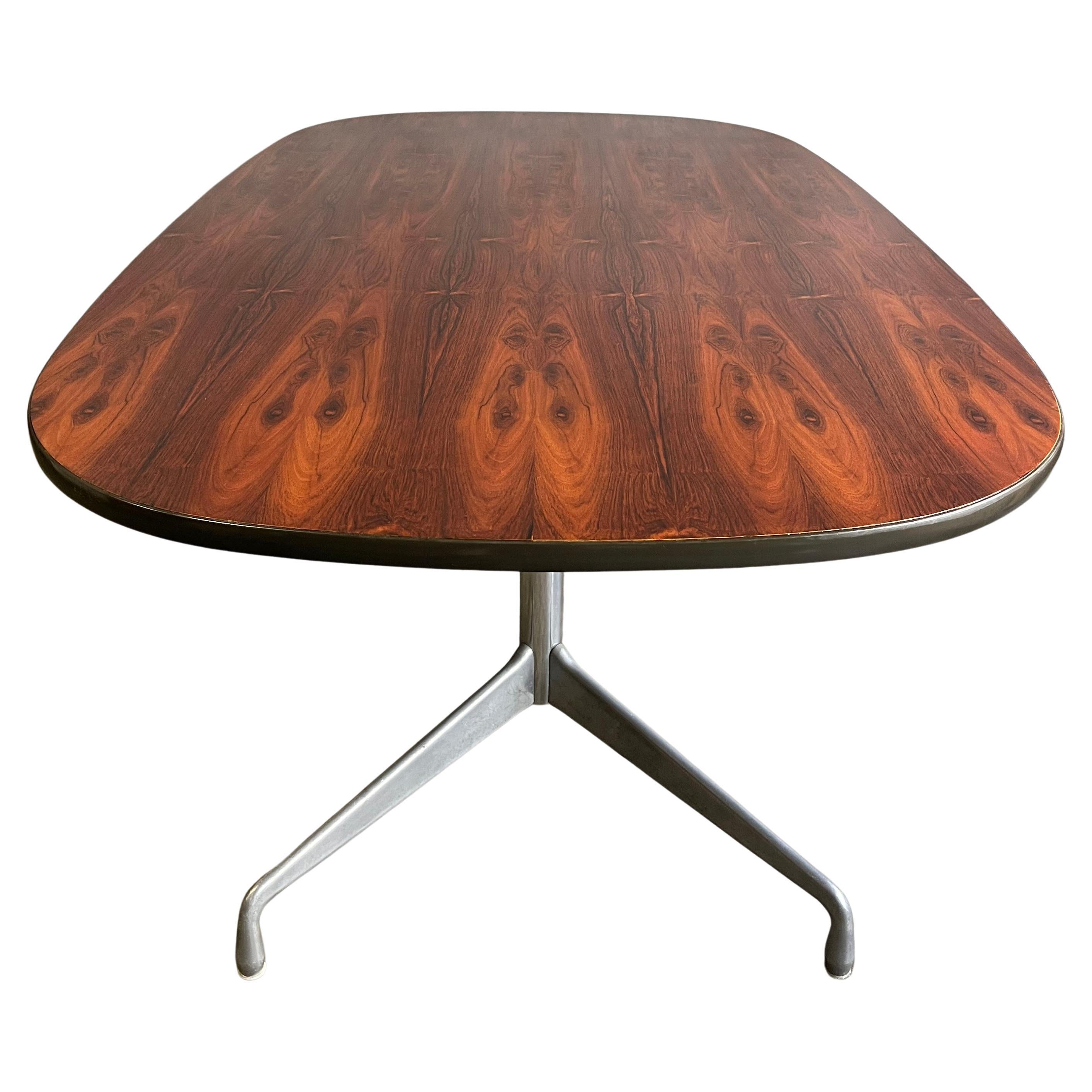 Herman Miller Eames rosewood conference or dining table. Gorgeous figurative grain detail and patterns. On rare polished chrome and aluminum segmented base. Rosewood has been discontinued since the early 1990s. This table is from the early 1970's.