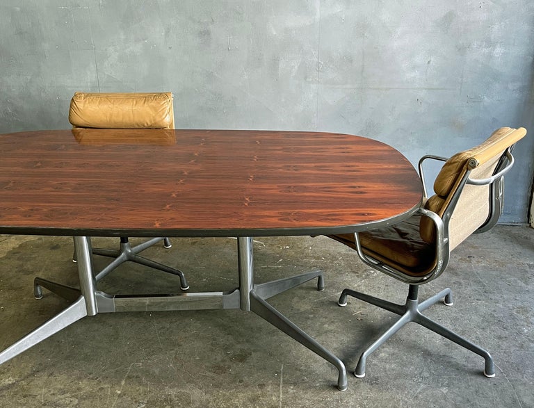 Herman Miller Eames rosewood conference or dining table. Gorgeous figurative grain detail and patterns. On rare polished chrome and aluminum segmented base. Rosewood has been discontinued since the early 1990s. This table is from the early 1970's.