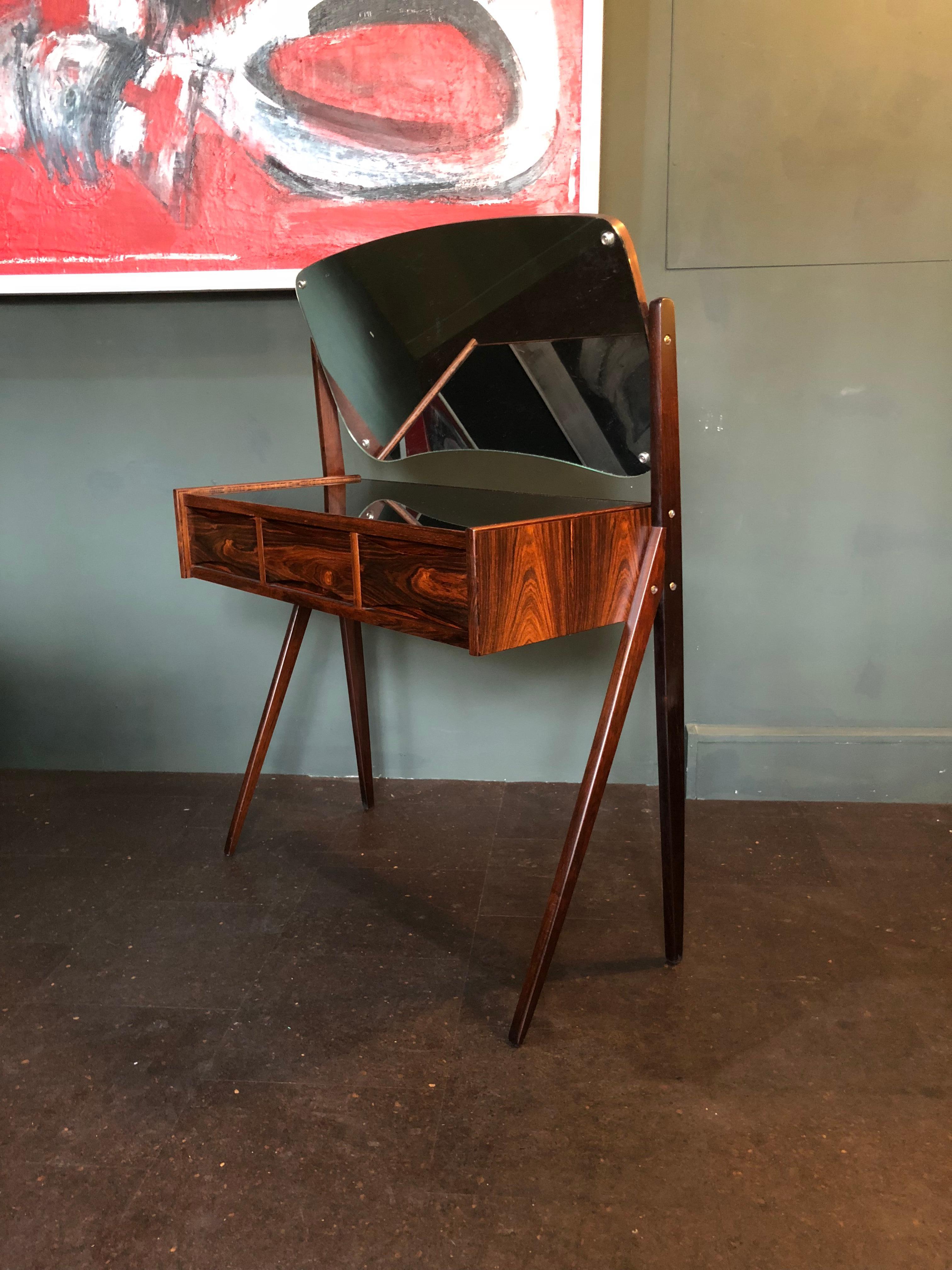 An Arne Vodder vanity unit. This is a superb piece of Scandinavian 20th century furniture with black glass surface and adjustable tilt mirror. Produced in Denmark, circa 1960. We have a well matched stool to go with this piece and it can be
