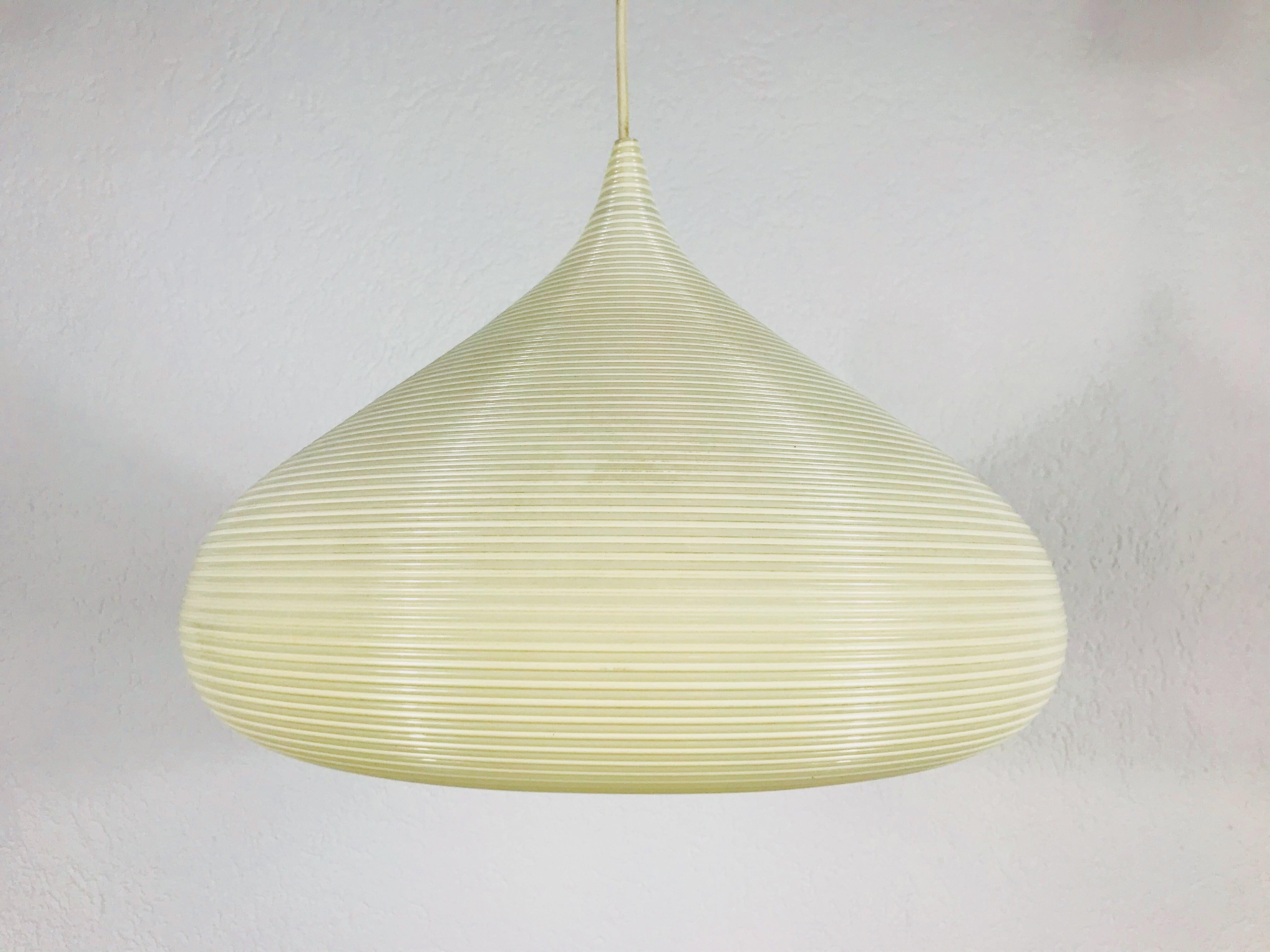 Mid-Century Modern Rotaflex pendant lamp made in the 1960s. The lamp shade is made of continuous plastic cords spun into a ceiling fixture. The top of the lamp is hard plastic. The lamp is in good vintage condition.

Measure: Maximum height of the