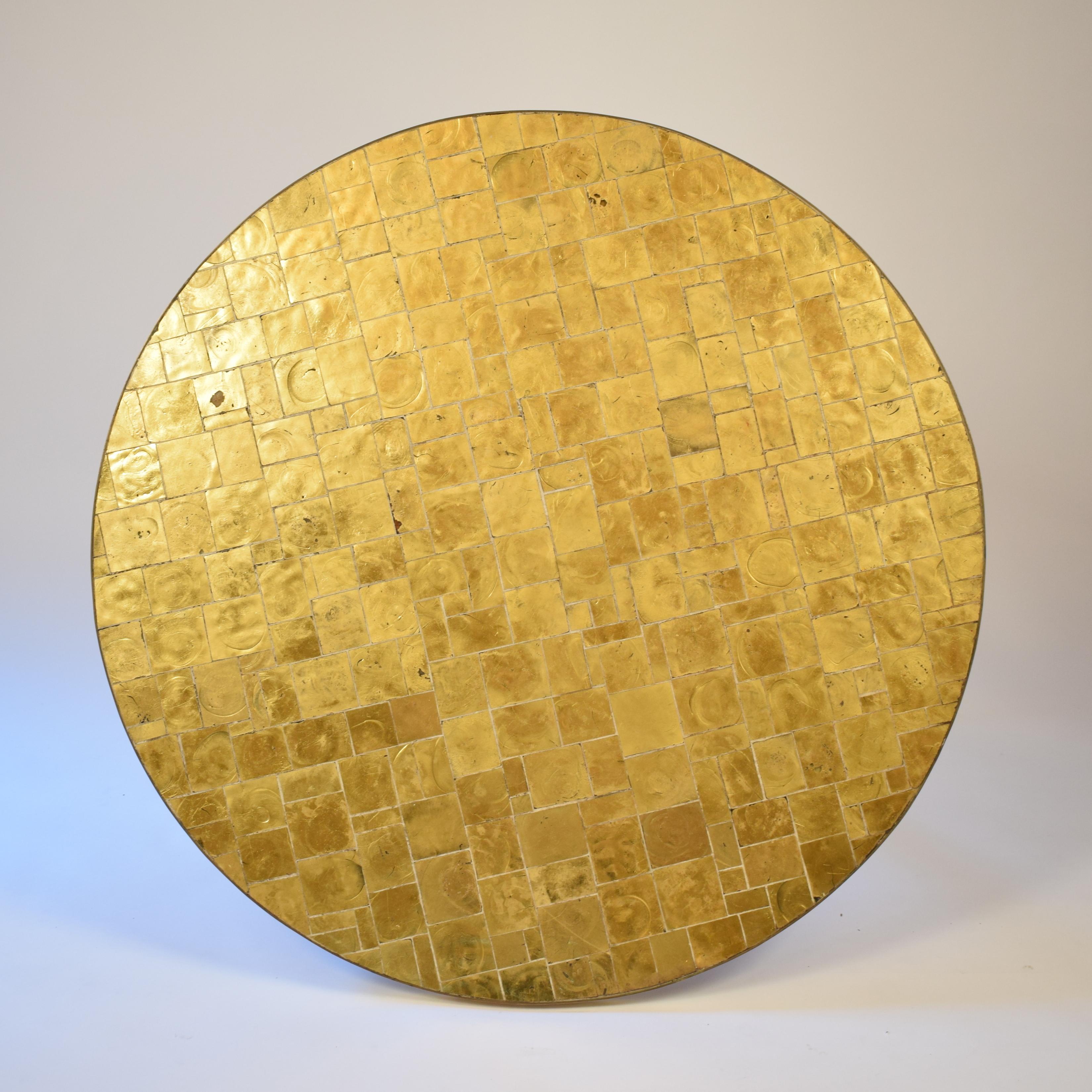 This elegant and beautiful round dining table was made in the 1970s. It has a gilded glass tiles top and the base is made out of brass.
A very unique and unusual piece. The tabletop has a very nice warm golden shine.
This piece of furniture is a