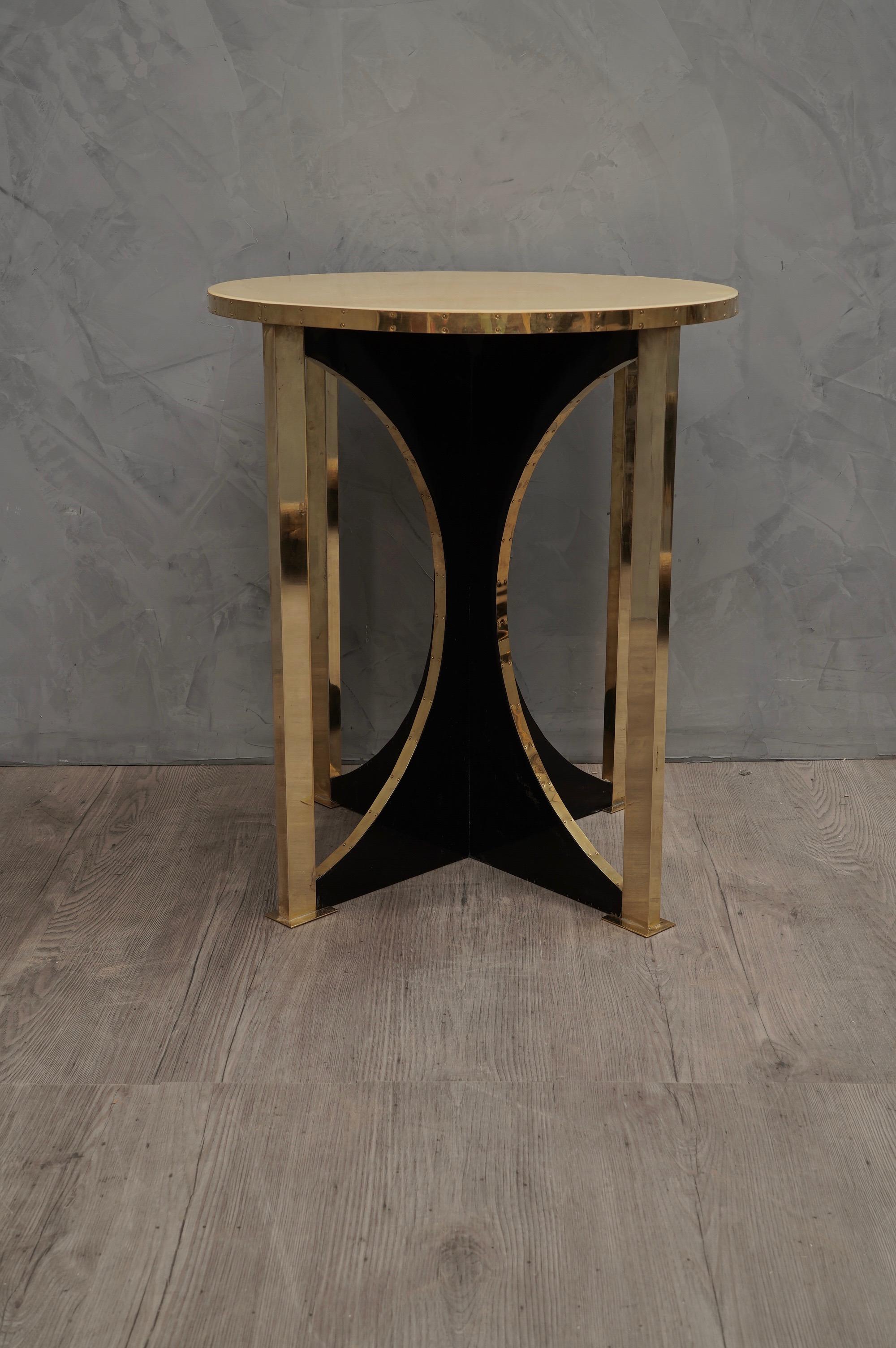 Fine and refined materials for a pair of very elegant side tables, shortly after the middle of the last century.

Top in circular shape completely covered in parchment leather, polished in resin. Below, particular the shape of the leg, wooden