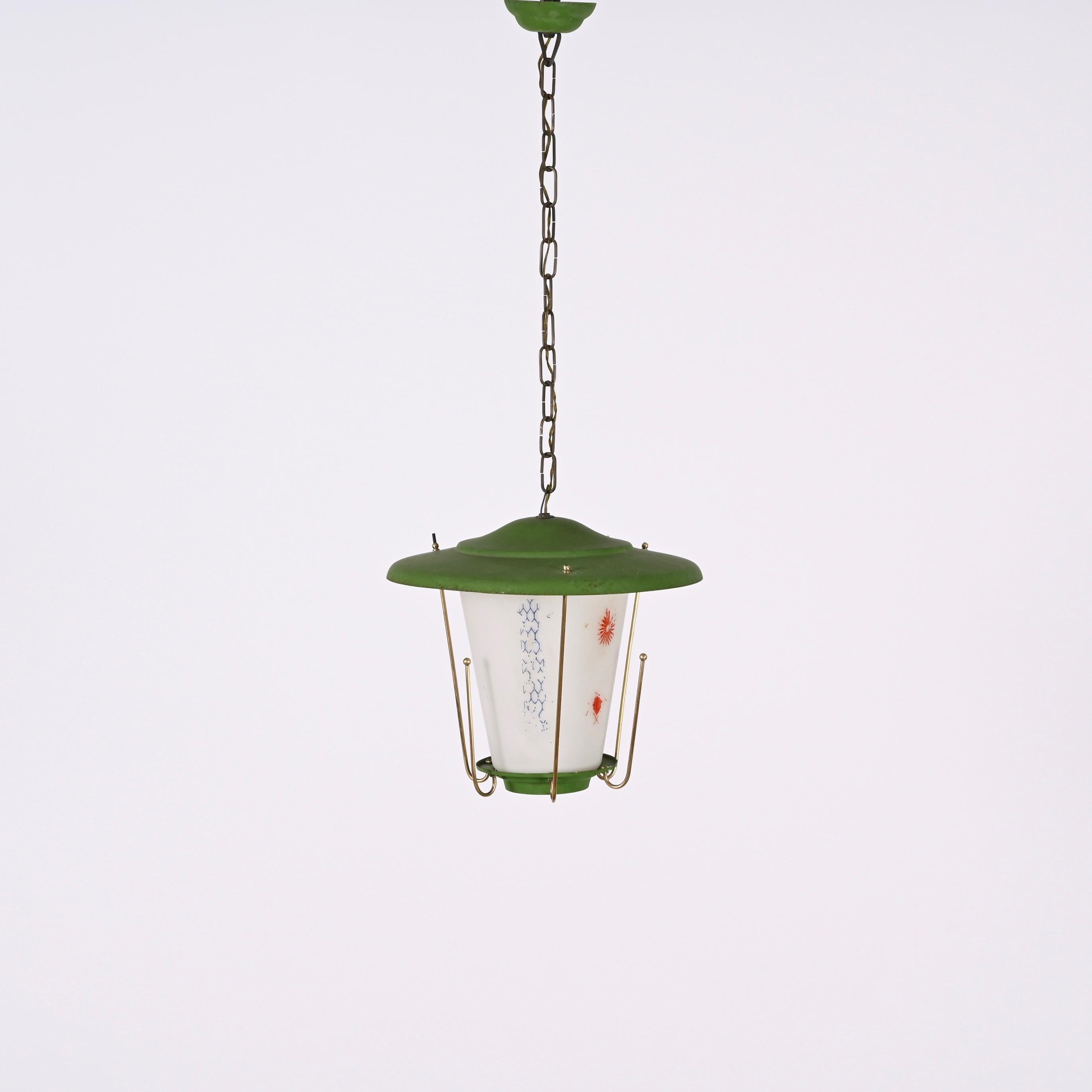 Amazing mid-century round opaline glass and brass green lantern chandelier. This fantastic piece was designed in Italy during the 1950s.

This piece is wonderful as the combination of materials and colours is very typical of the time and the with