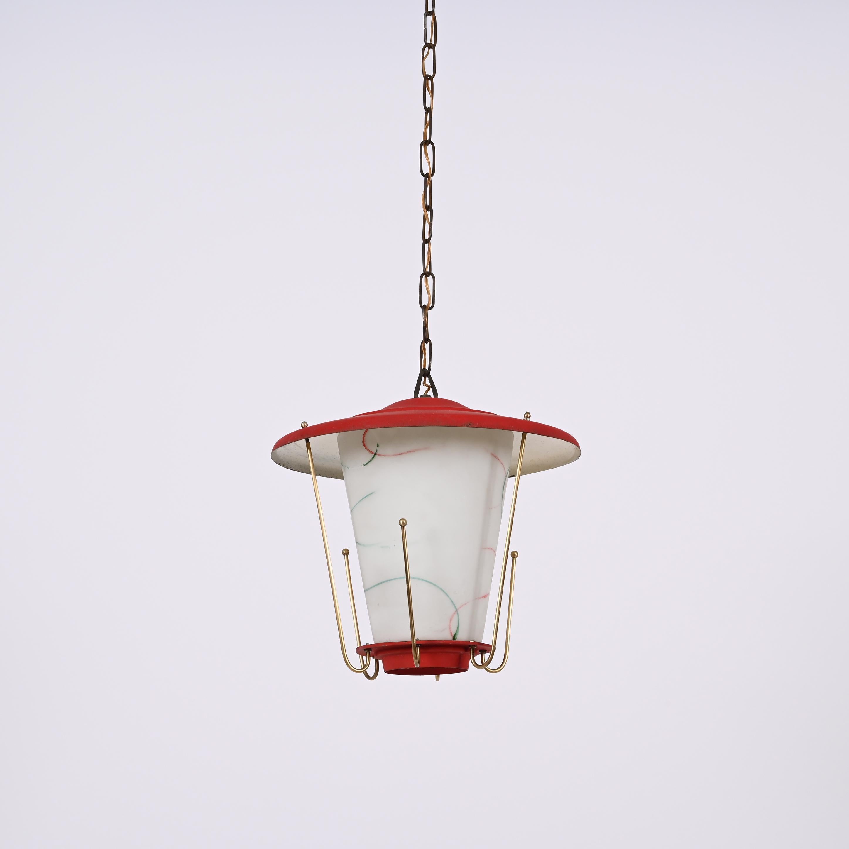 Amazing midcentury round opaline glass and brass red lantern chandelier. This fantastic piece was designed in Italy during the 1950s.

This piece is wonderful as the combination of materials and colours is very typical of the time and the with