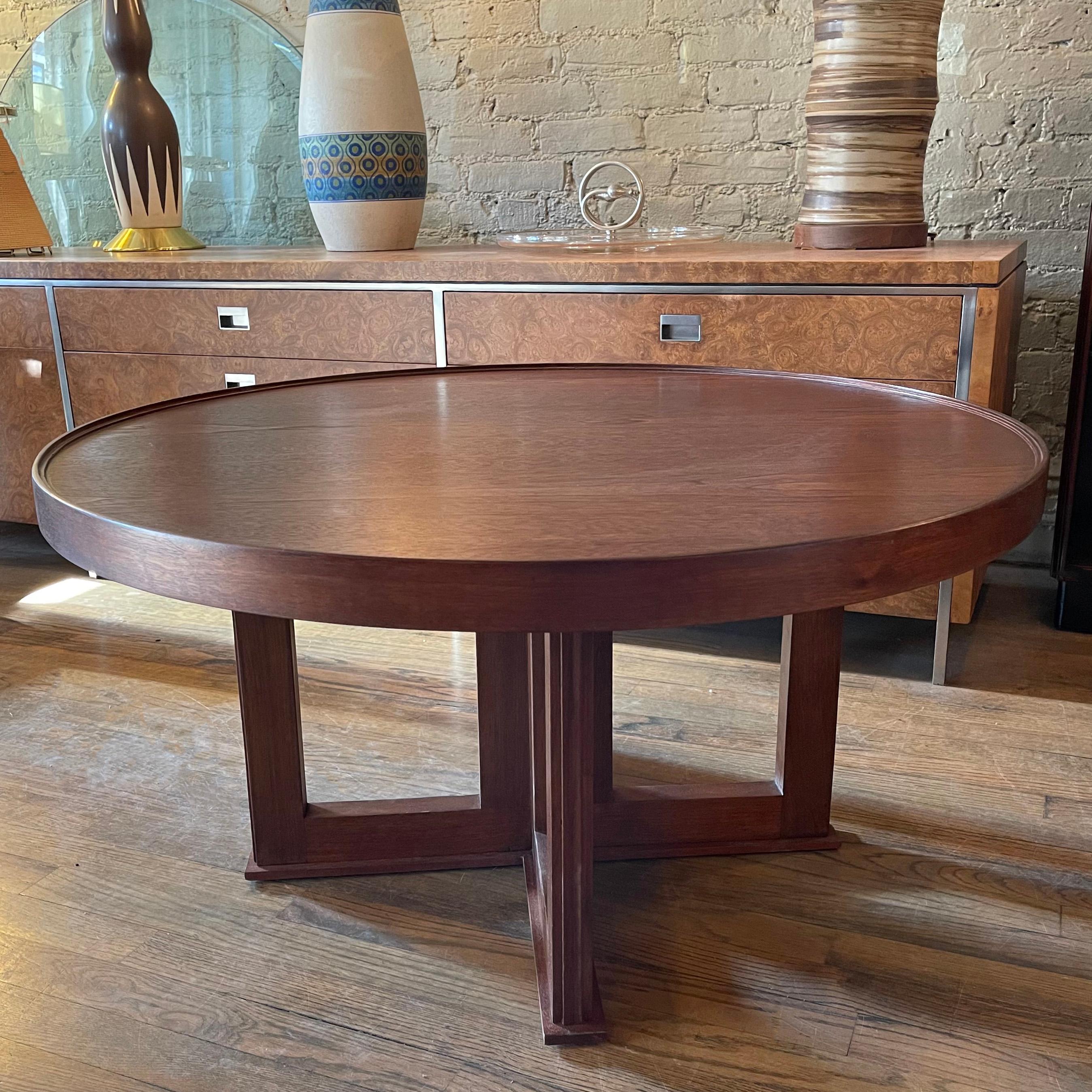 Nicely detailed, 1940s midcentury, walnut coffee table features a 34 inch round top with tray top and geometric base.