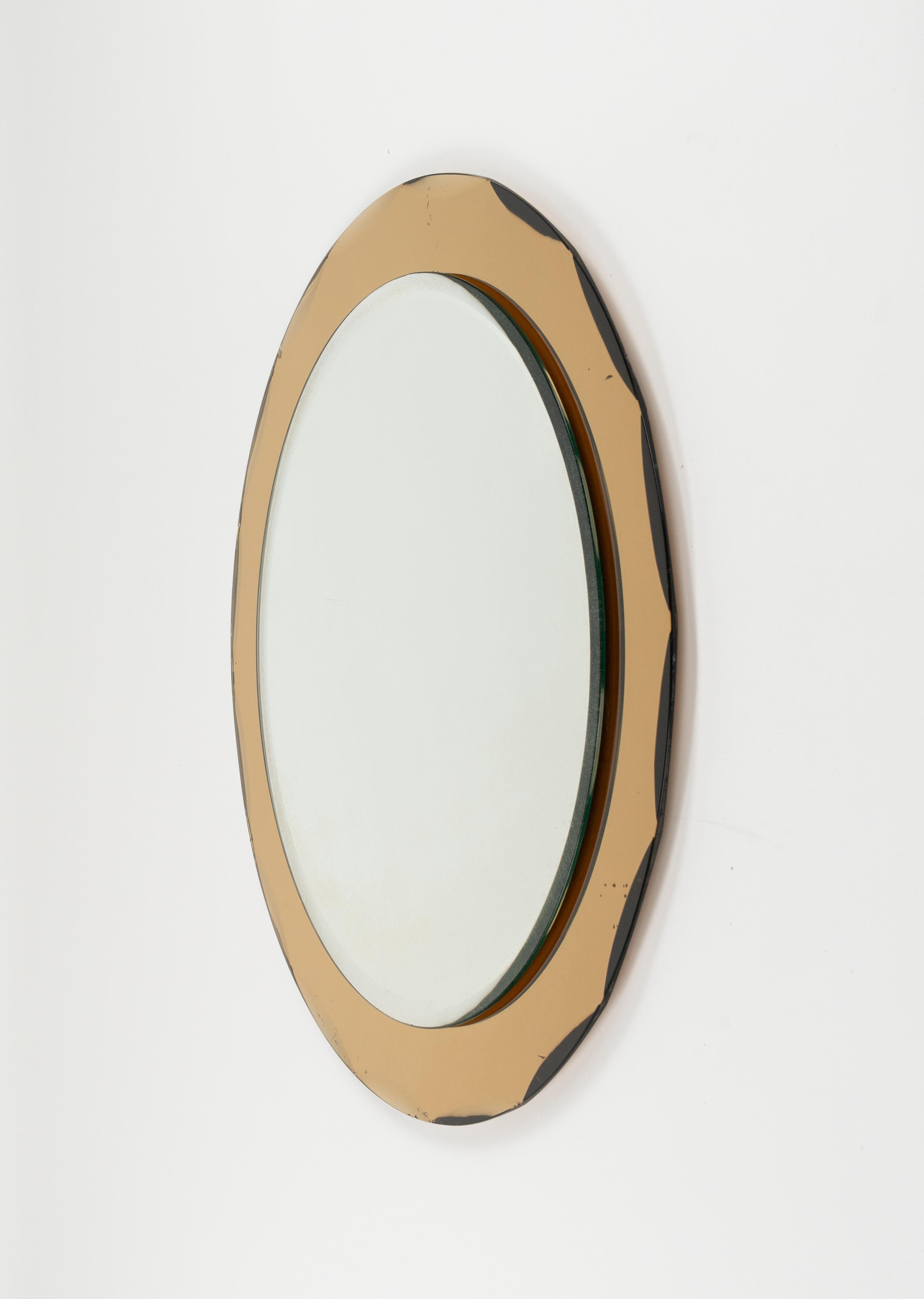 Midcentury amazing round wall mirror with yellow mirror frame and double decreasing beveled by Metalvetro Galvorame.   

Made in Italy in the 1970s. 

The mirror, original of the period, shows small signs of discolouration.