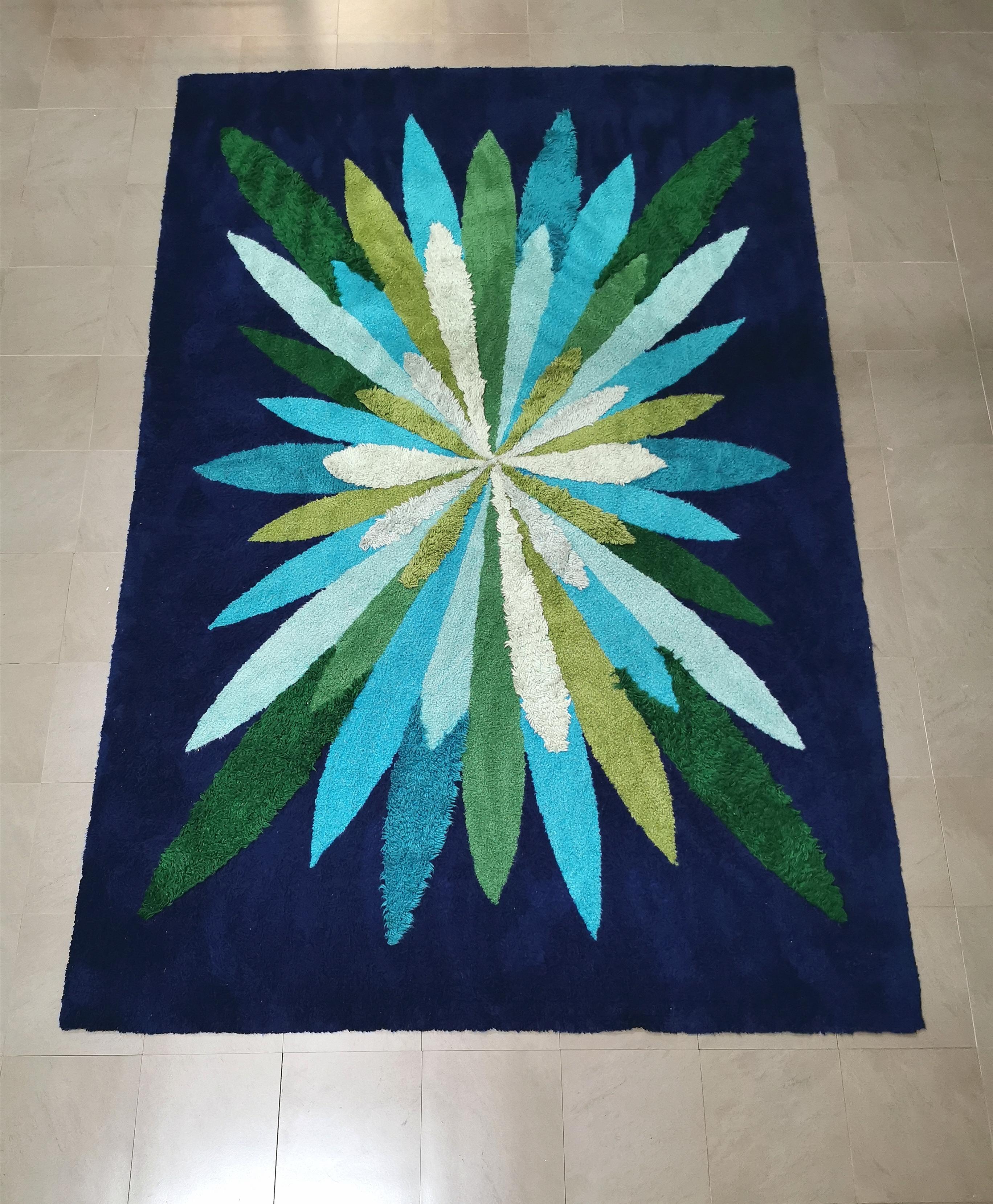 Particular rectangular rug in electric blue wool fabric with multicolored wind rose representation. Made in Italy in the 70s.