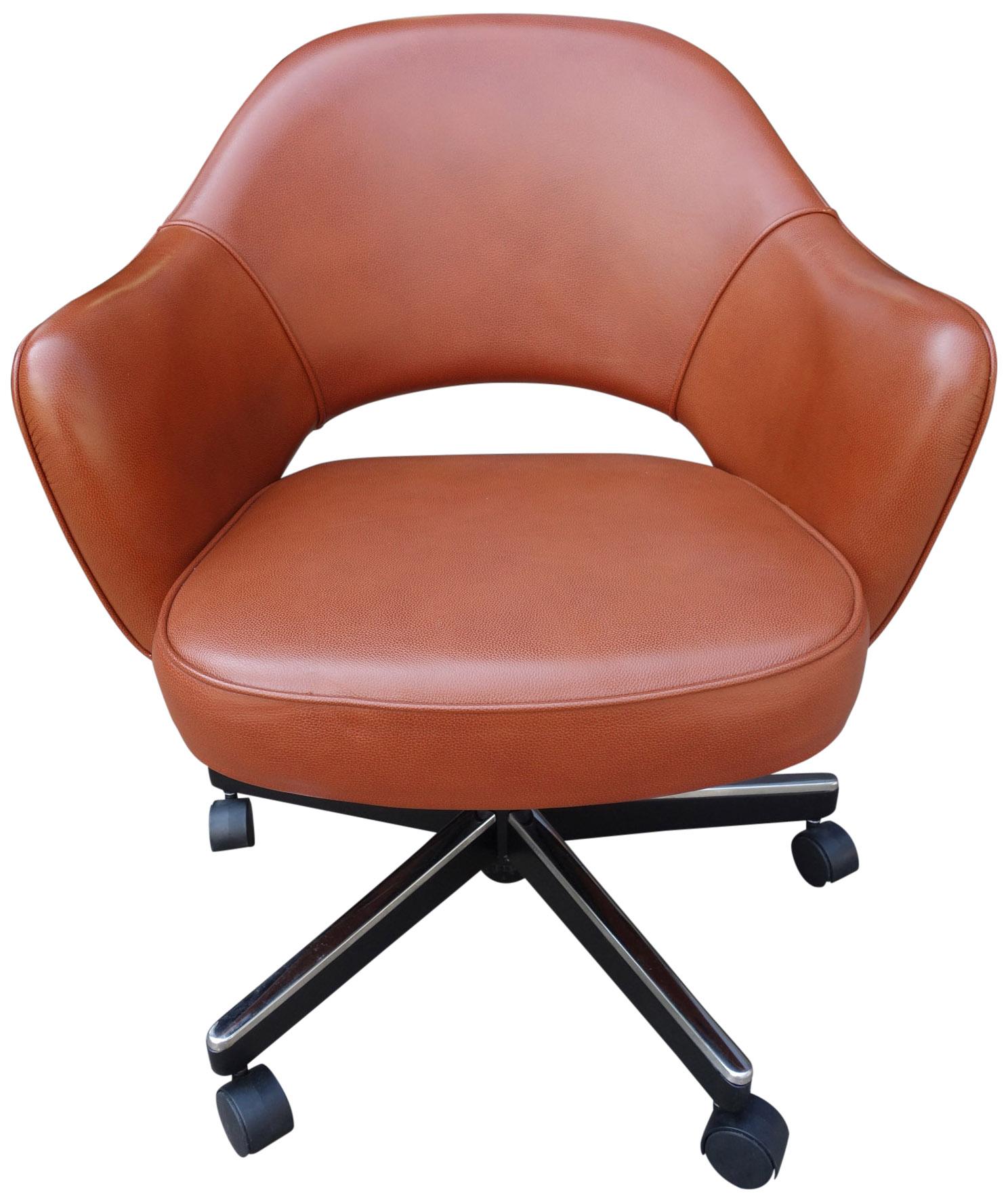 Midcentury Saarinen Executive chairs in reddish brown leather. All with adjustable pneumatic height and tilt positions. This iconic design has been a favorite in both the home and corporate settings due to its sharp looks and comfort. Seat height