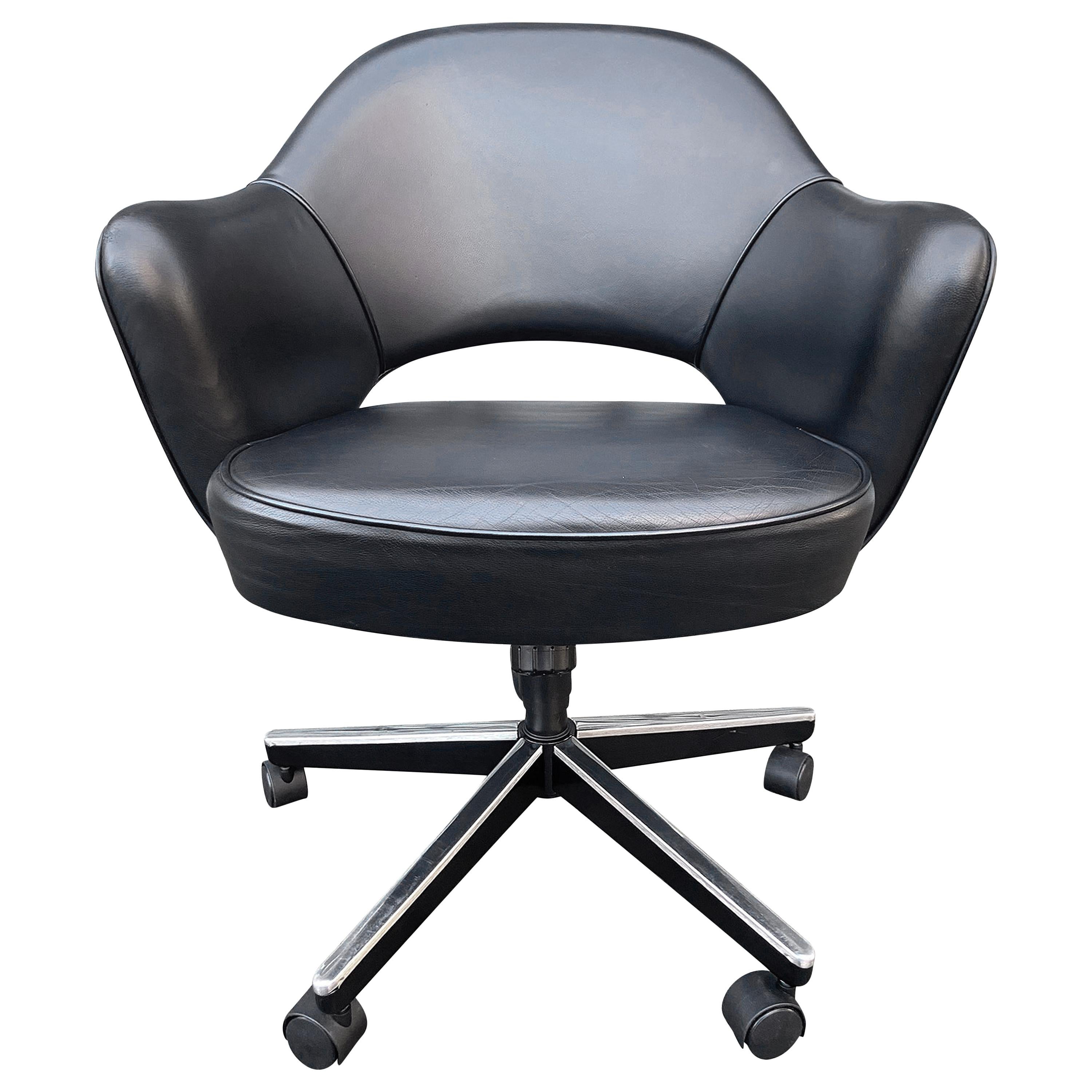 Midcentury Saarinen executive chairs in black leather. All with adjustable manual height and tilt positions. This iconic design has been a favorite in both the home and corporate settings due to its sharp looks and comfort. Seat height adjustable to
