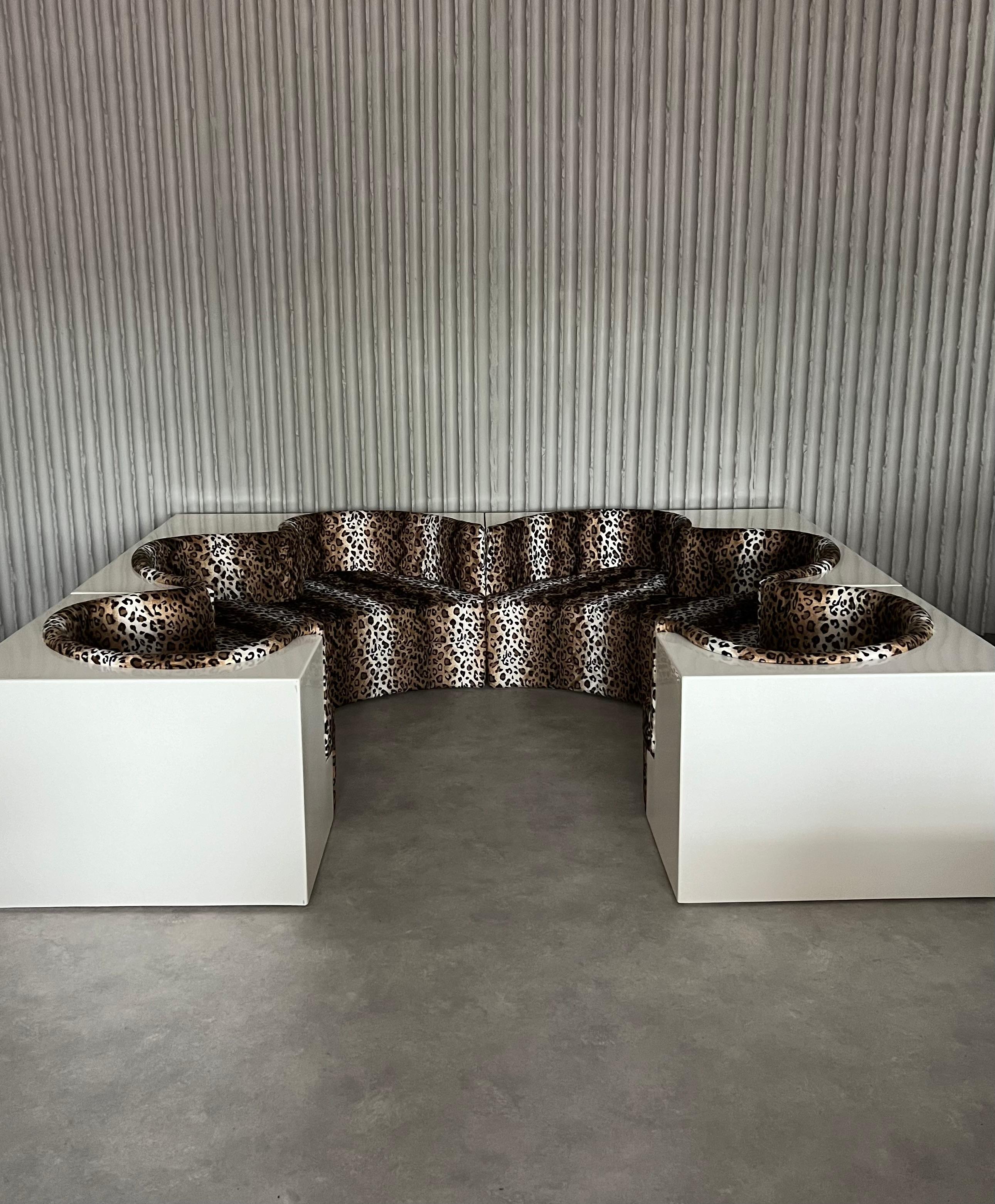 An icon, vintage Safari sofa by Archizoom Associati for Poltronova. A base made of white-coated fibreglass reinforced plastic, integrated seats arranged in the form of a flower, newly upholstered and covered with fake leopard Same as original