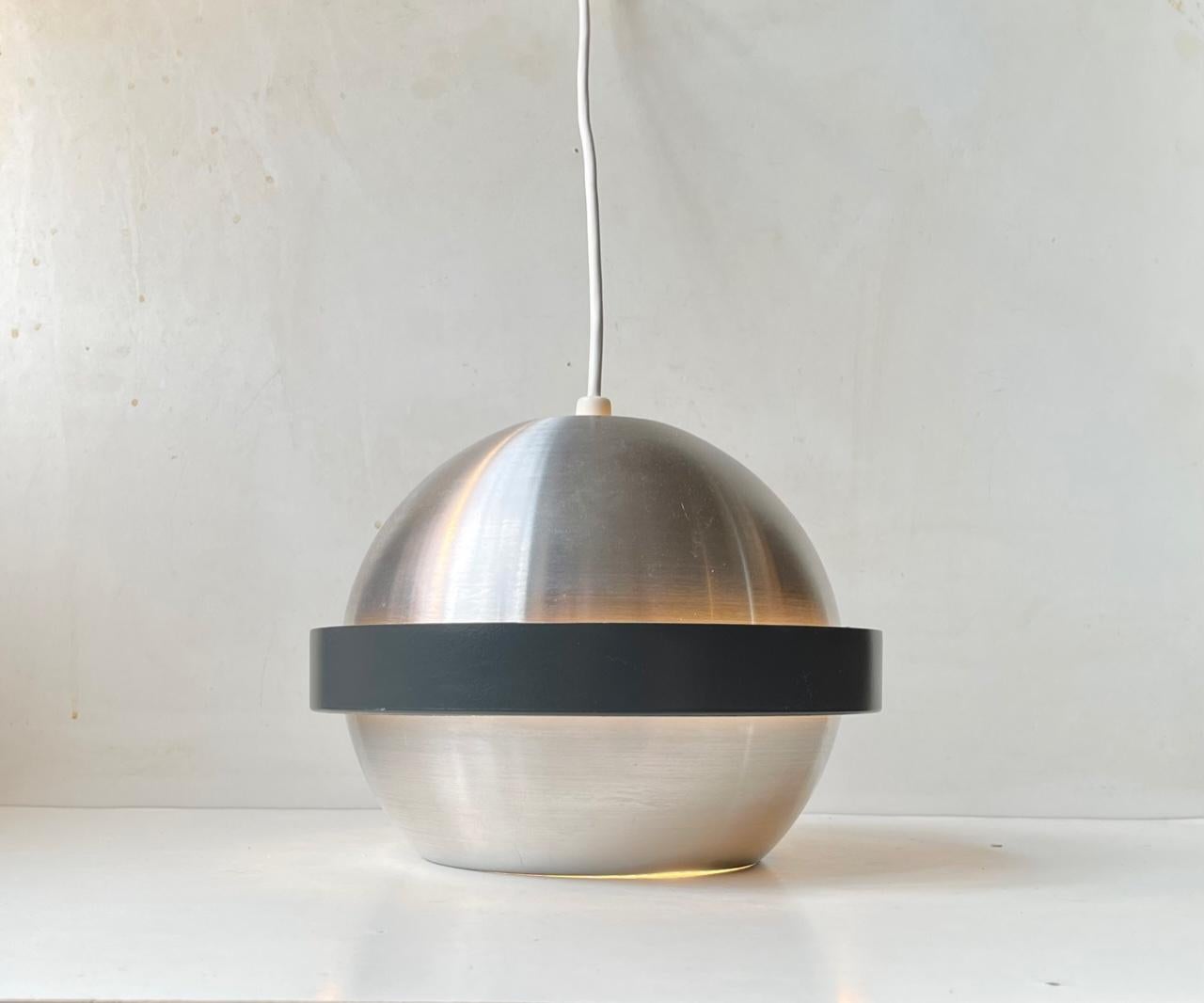 Hanging light in brushed aluminium micmic'ing the planet Saturn. Its matte black ring diffuses the light softly around the perimeter. It was designed and made by Fagerhult in Sweden during the 1970s. It closely resembles designs by Jo Hammerborg for