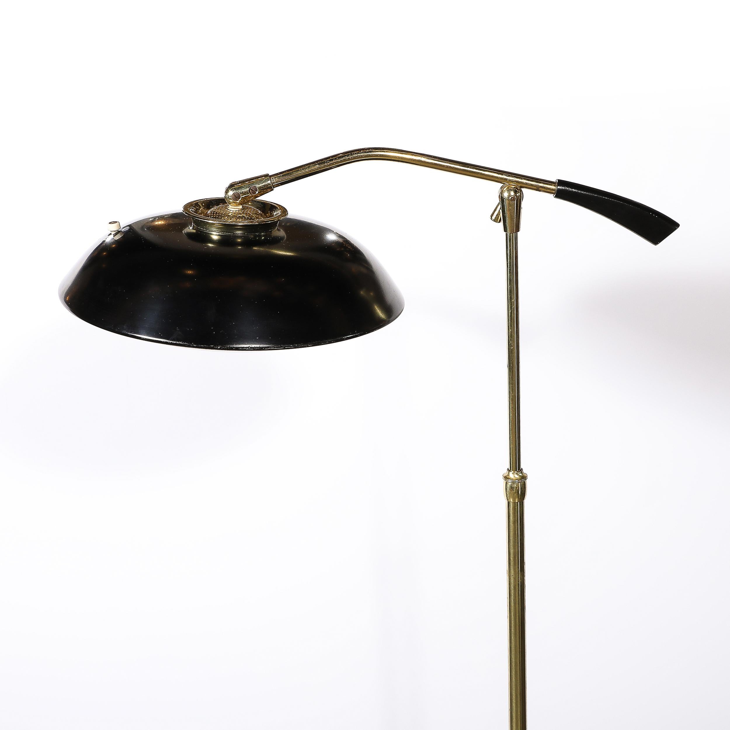 This beautifully fabricated Mid-Century Modernist Saucer Articulating Floor Lamp in Brass and Black Enamel by Gerald Thurston originates from the United States, Circa 1960. This gorgeous floor lamp features a curved top form base in black enamel