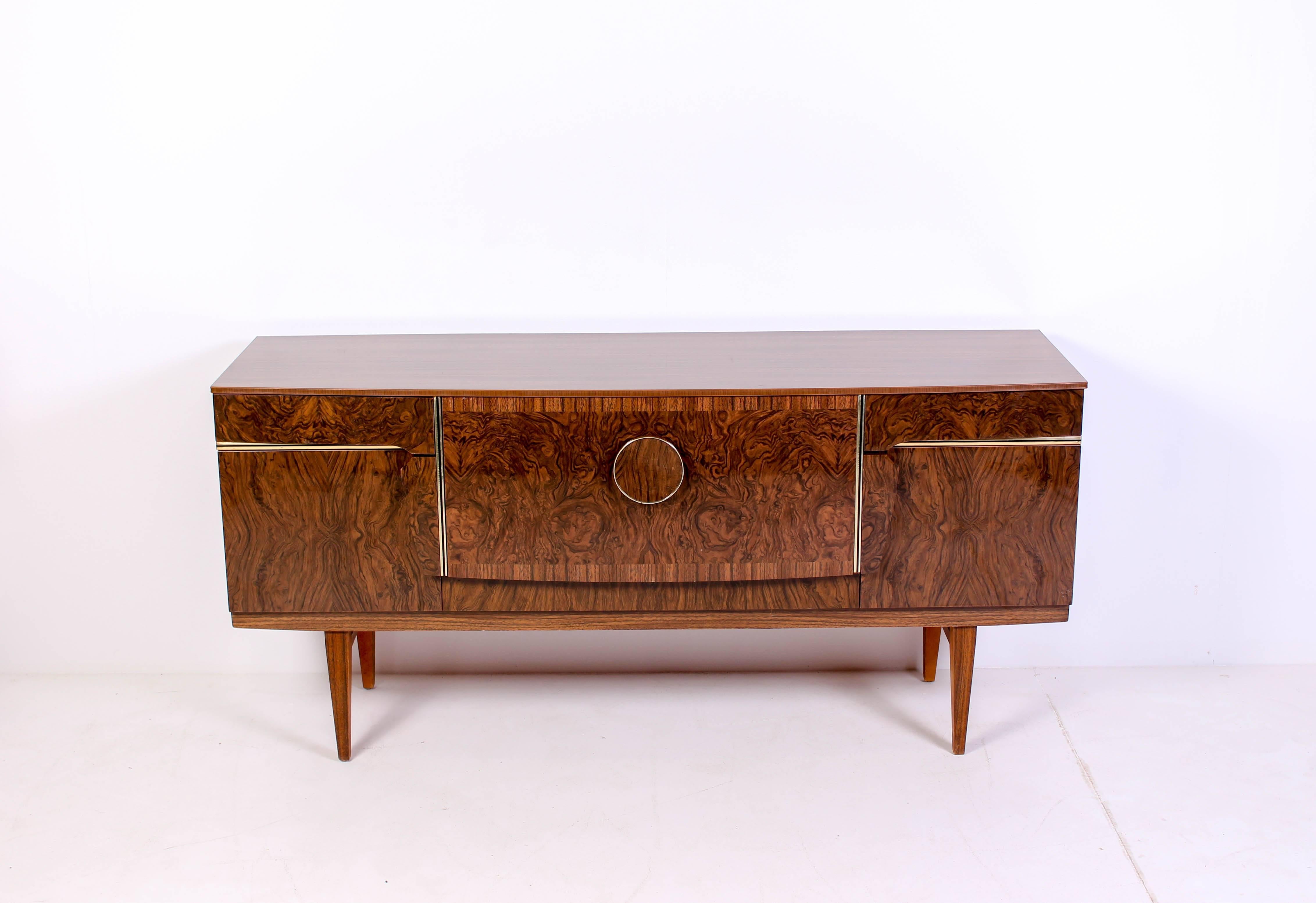Midcentury Scandinavian sideboard by unknown designer. The sideboard (credenza) has a bar with built-in lightning. The sideboard also have brass details and beautifully shaped handles. 

Very good vintage condition with signs of usage consistent