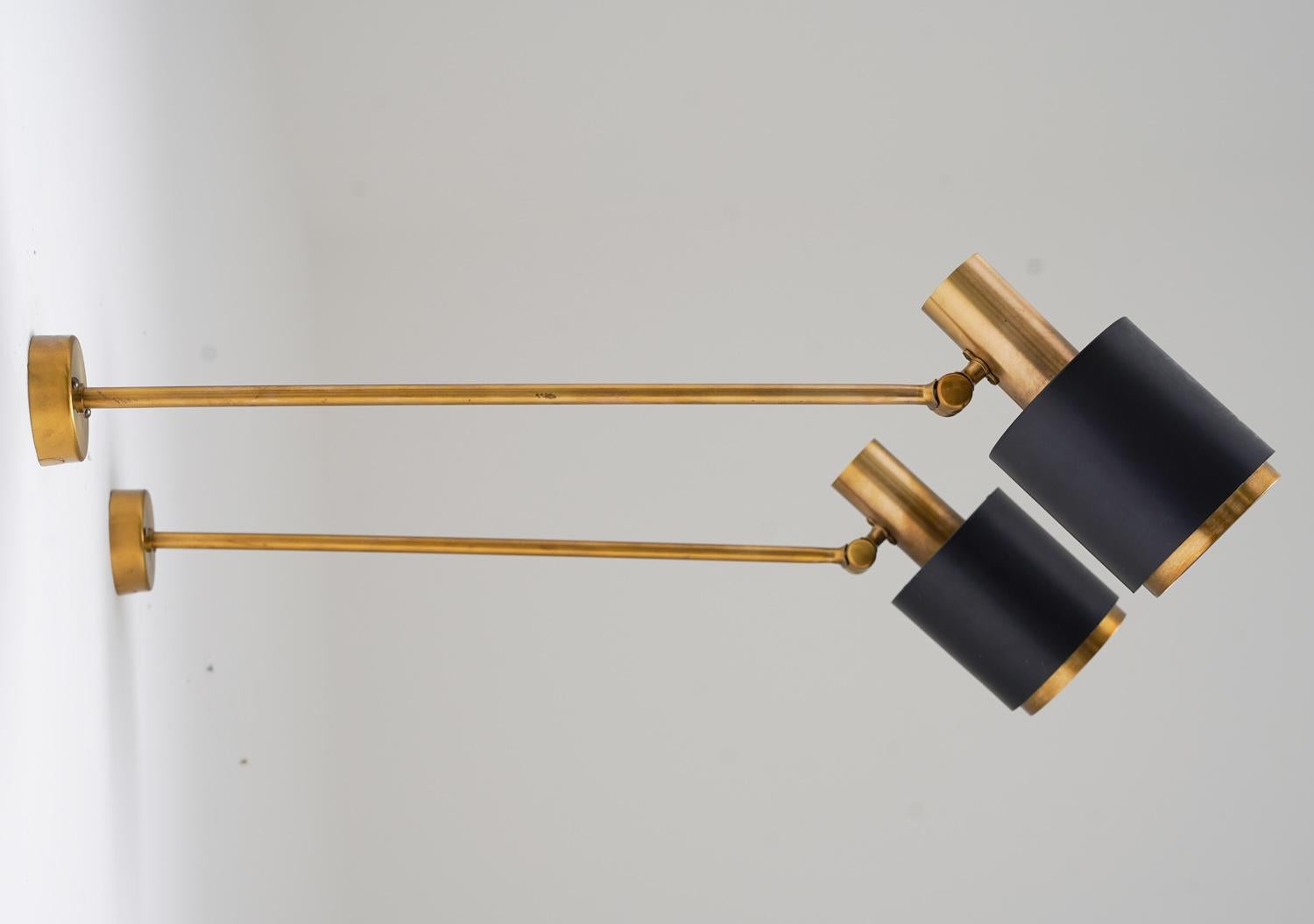 Rare midcentury wall lamps, produced by Falkenbergs, Sweden 1960s.
The lamps feature a long brass rod, holding the adjustable shade.

Condition: Very good original condition with a few light scratches on the shades.

Wiring: All our lamps are wired