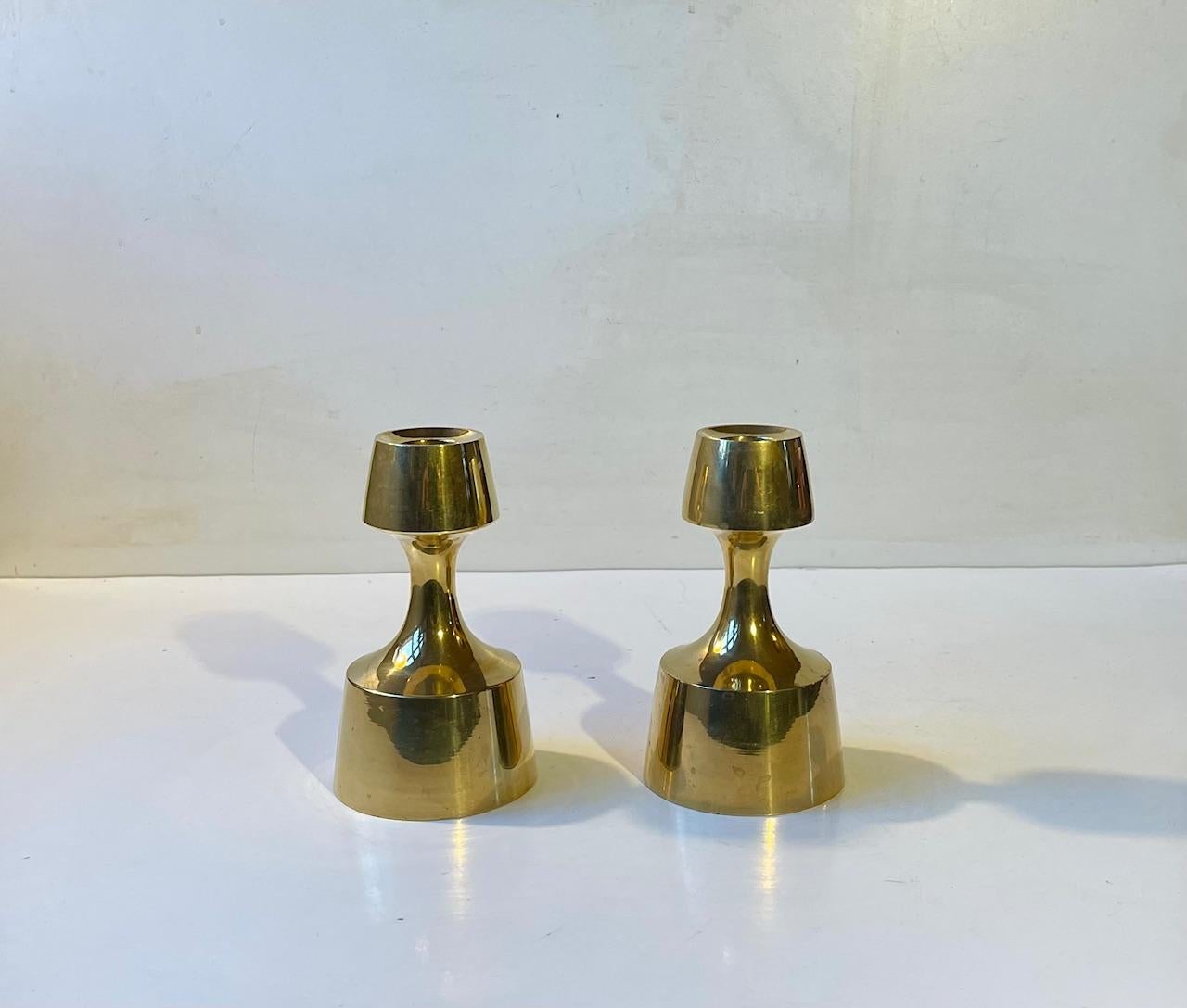 A pair of solid brass candlesticks designed and manufactured by by Cohr in Denmark during the 1960s. The candlesticks are to be fitted with regular sixed candles. The style of this set is reminiscent to Jens Harald Quistgaard and Cohr Fredericia.