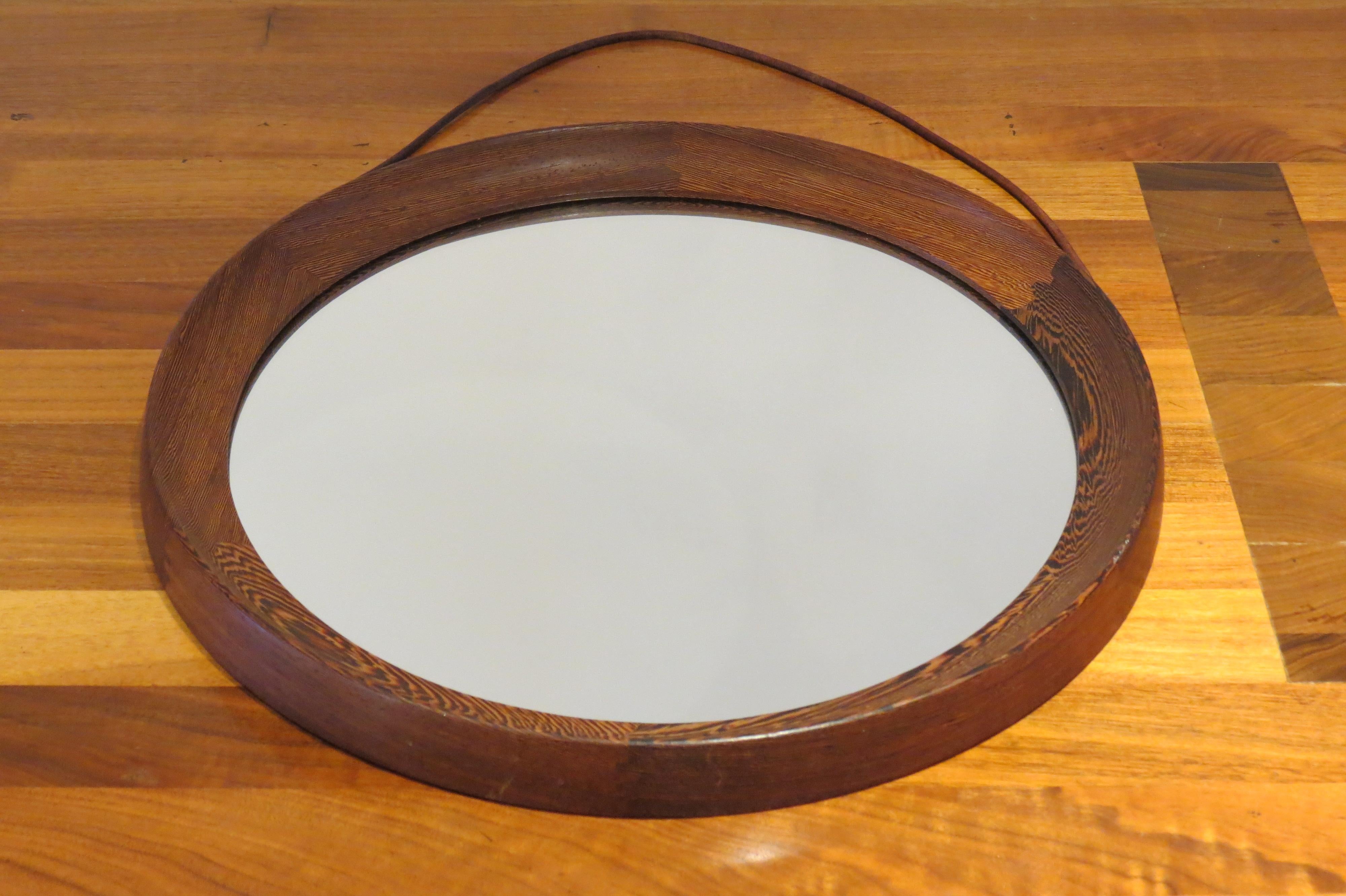 Swedish circular wall hanging mirror by Uno and Osten Kristiansson and manufactured by Luxus, Sweden.

Solid wengé with detailed joints, glass mirror plate and leather strap.

Good vintage condition.

ST732.