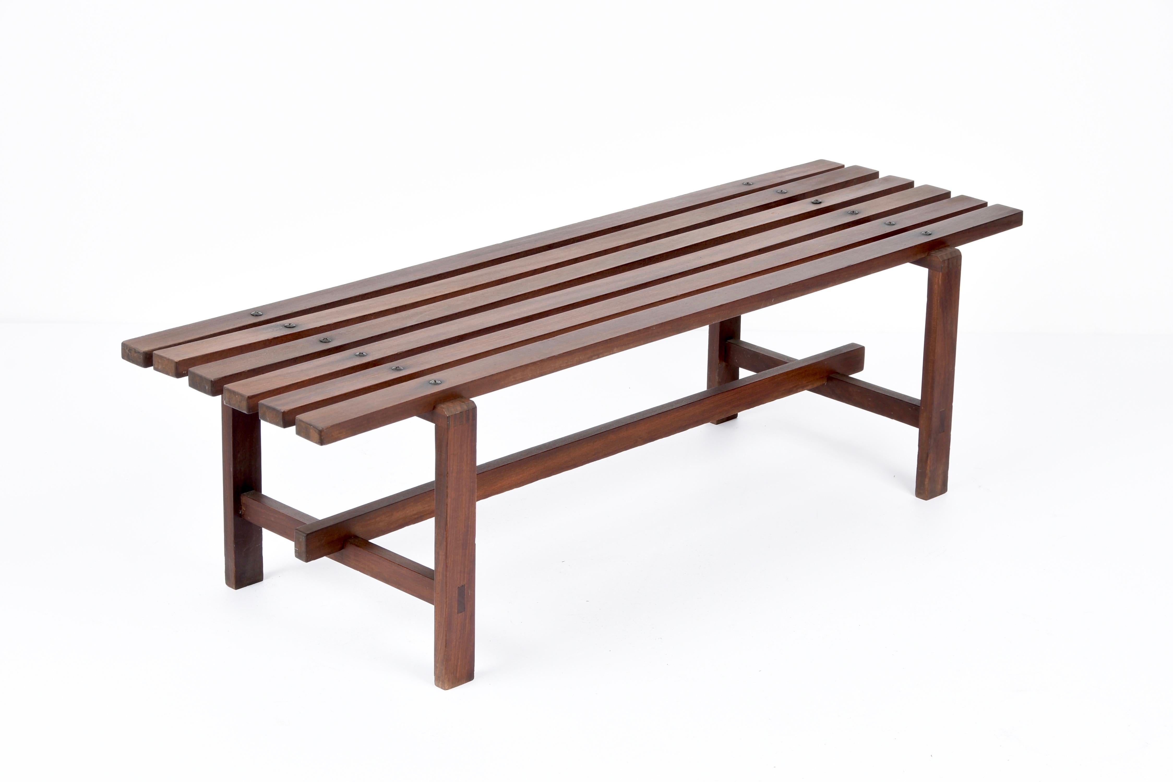 Marvellous midcentury bench made of dark brown teak wood. This item is a Scandinavian production of the 1960s. 

The piece is made of six horizontal wooden pieces for the seat and of a structure made of similar smaller elements.

An excellently
