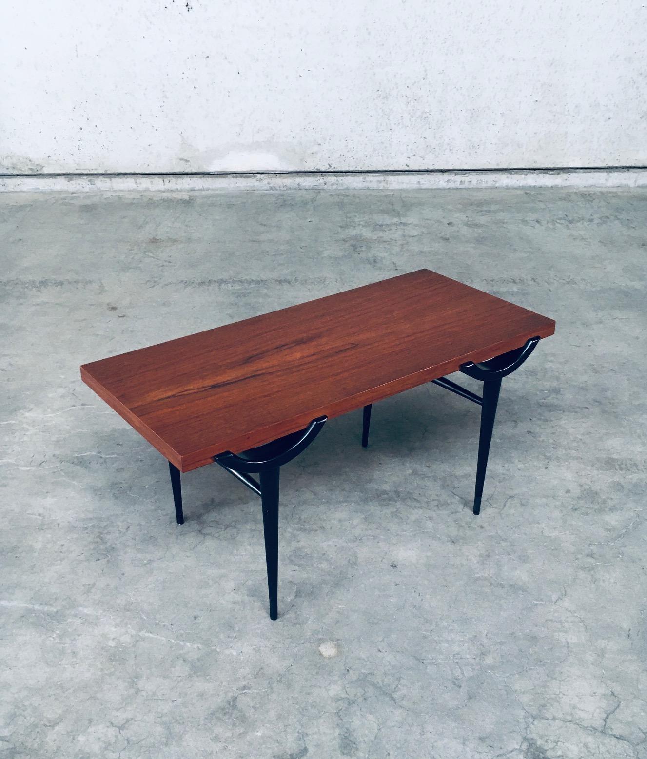 Vintage Midcentury Modern Scandinavian Design Side Table in the manner of Johannes Andersen. Made in Denmark, 1960's period. Teak rectangular top with black lacquered legs. This comes in very good condition. Measures 49,5cm x 100cm x 47cm.
